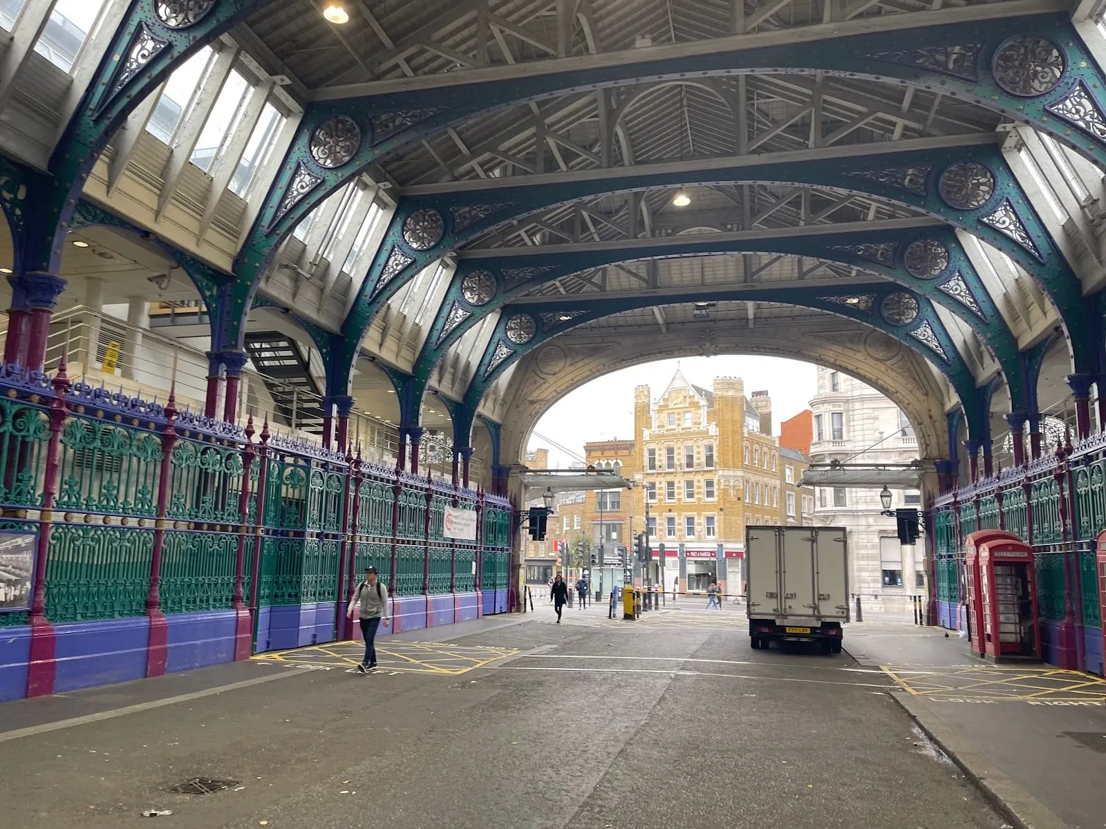 The colourful iron and glass roof of the covered walkway through Smithfield's Victorian General Market
