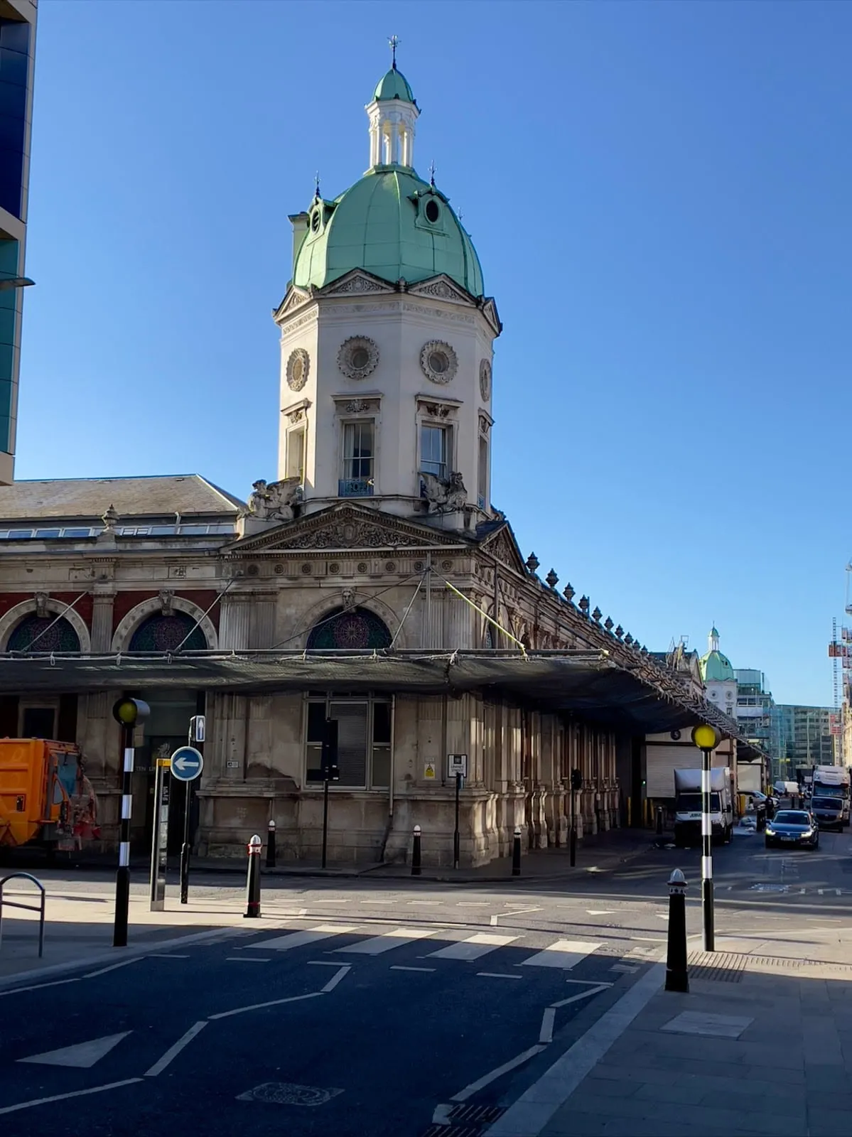 The Victorian market building at Smithfield with its green-domed corner tower, on a clear morning