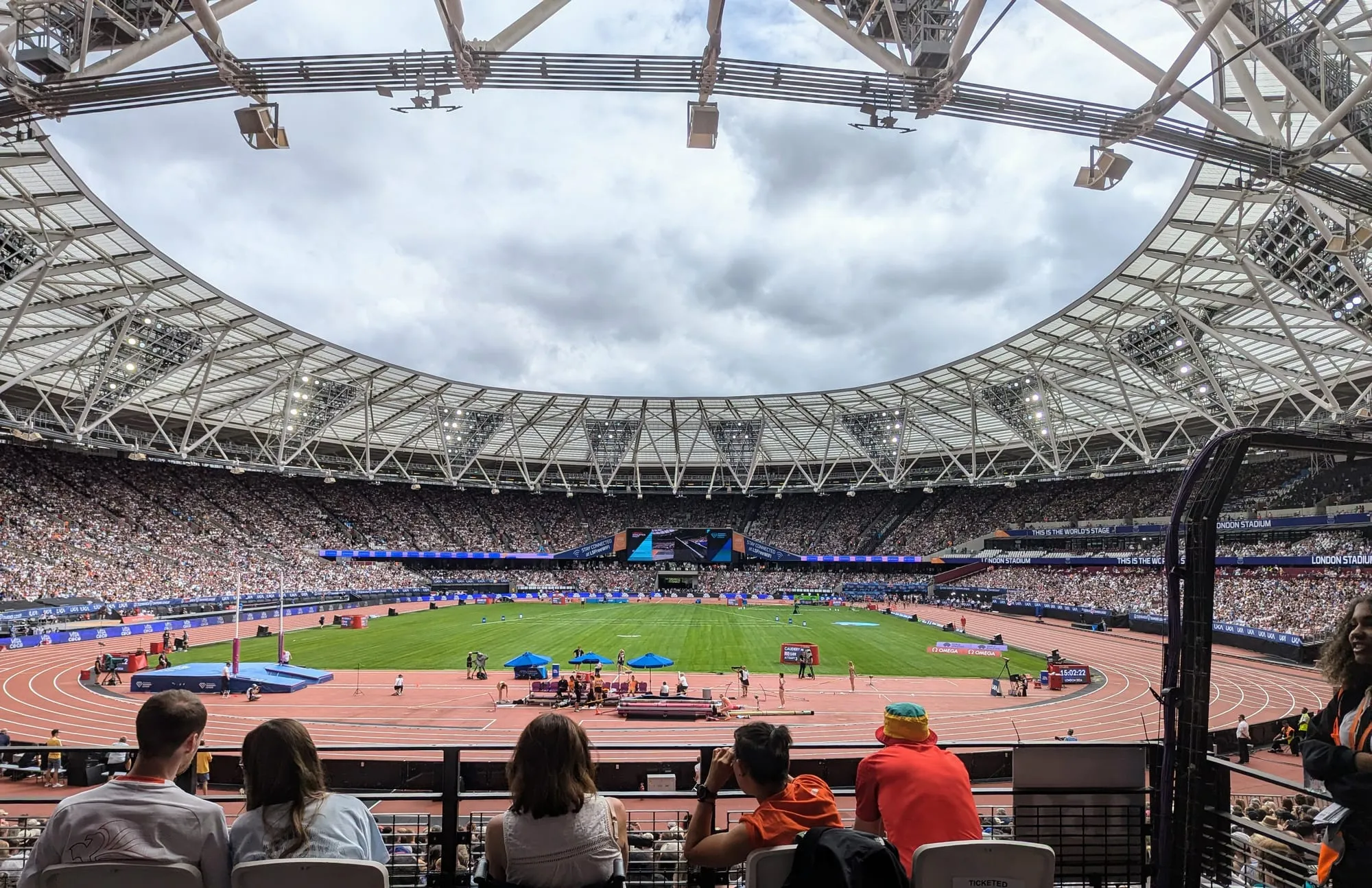 Inside London Stadium during the Novuna London Athletics Meet, a packed crowd under the distinctive roof and "LONDON STADIUM" branding on the pitch-side screens