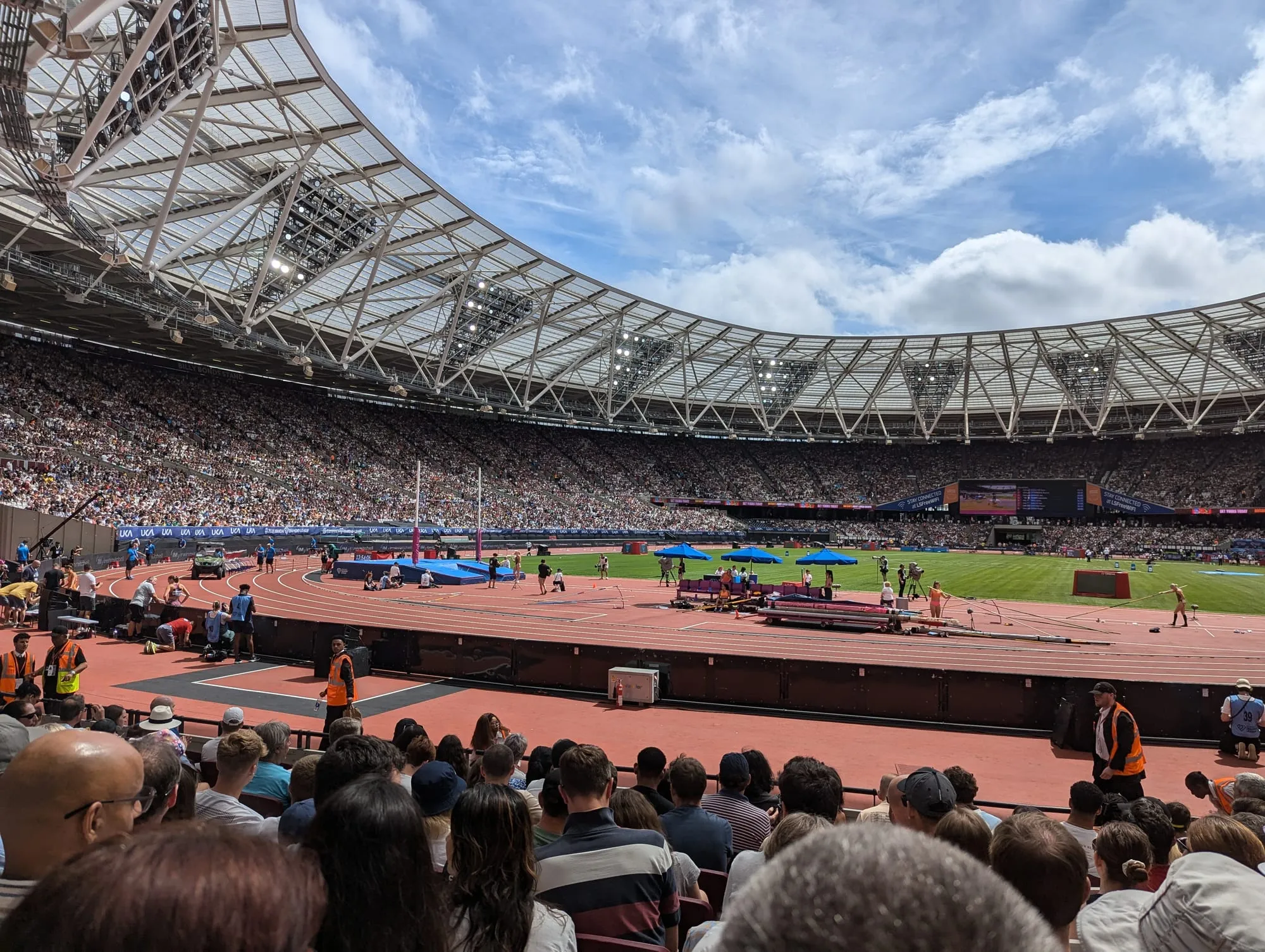 The track and infield at London Stadium during a full house for the athletics meet, the running track and field events visible under the open roof