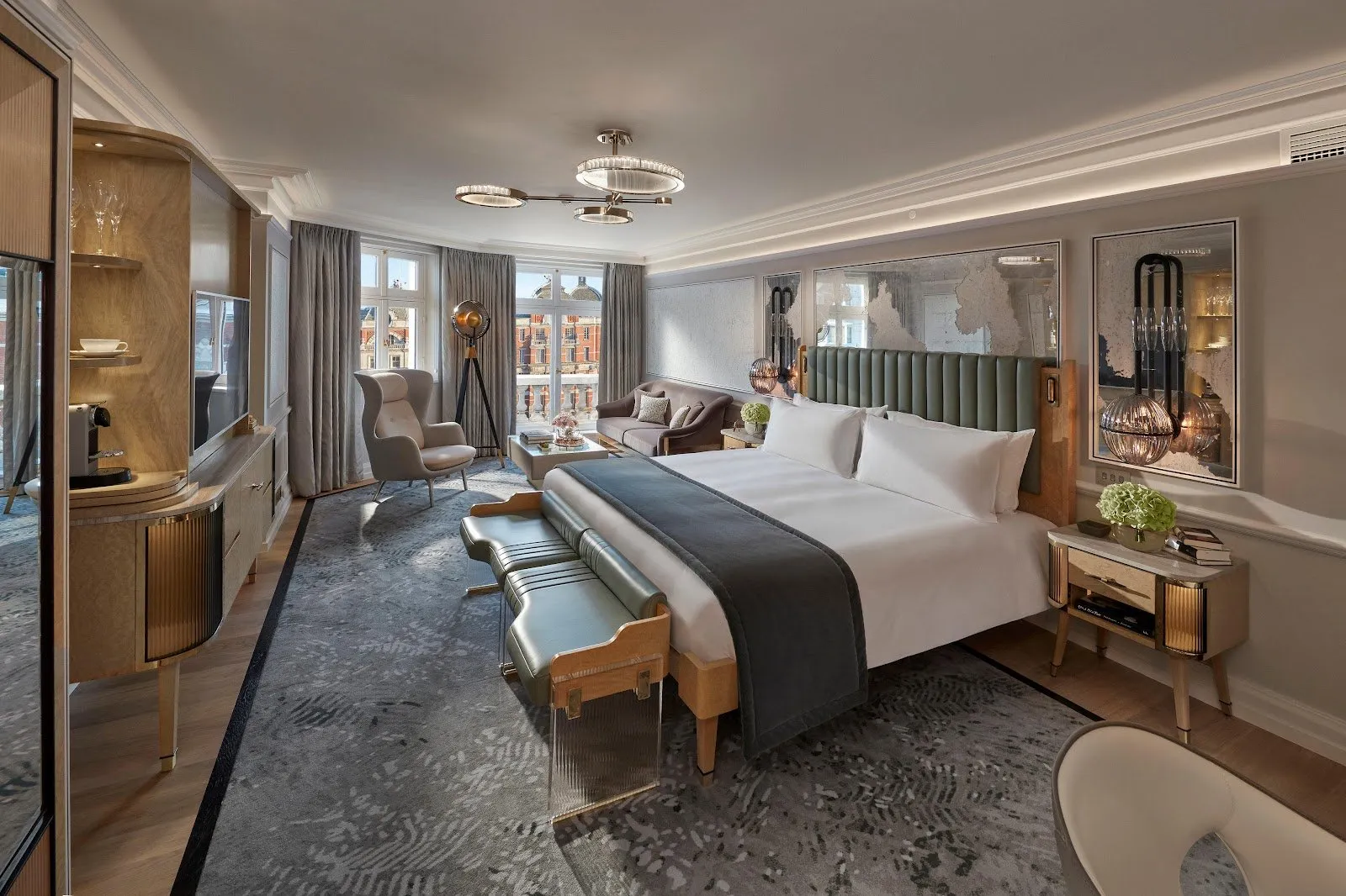A bedroom at Mandarin Oriental Hyde Park with grey upholstered headboard, velvet daybed and large windows