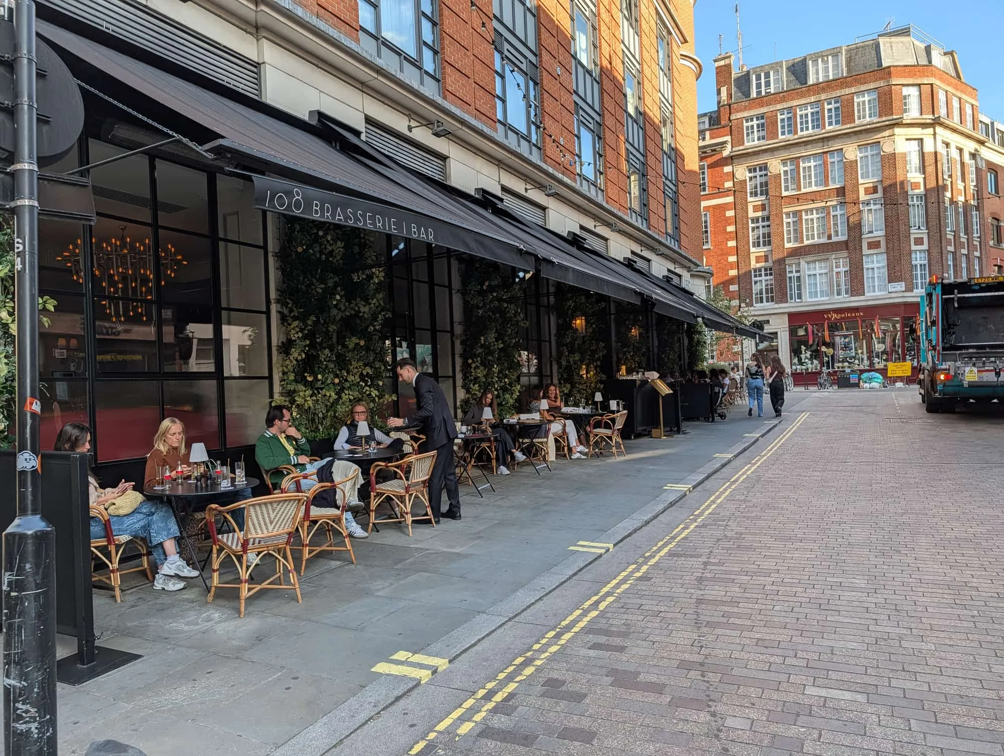 Outdoor tables outside 108 Brasserie on the curve of Marylebone Lane