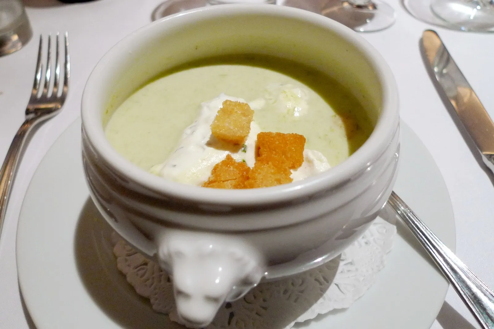 A tureen of soup with croutons on a lion-footed bowl