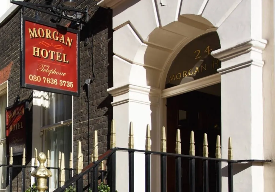 The arched white entrance portico of Morgan Hotel at 24 Bloomsbury Street with its red sign and iron railings