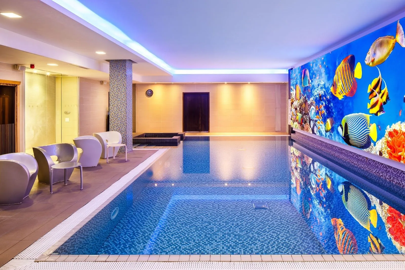 The indoor pool at Novotel London Blackfriars, with a coral-reef mural along one wall
