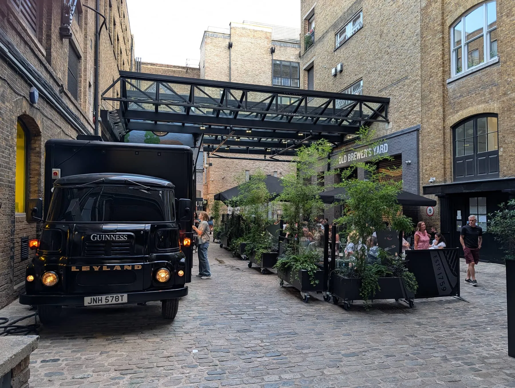 The cobbled courtyard of Old Brewer's Yard with a vintage Guinness delivery lorry parked in it