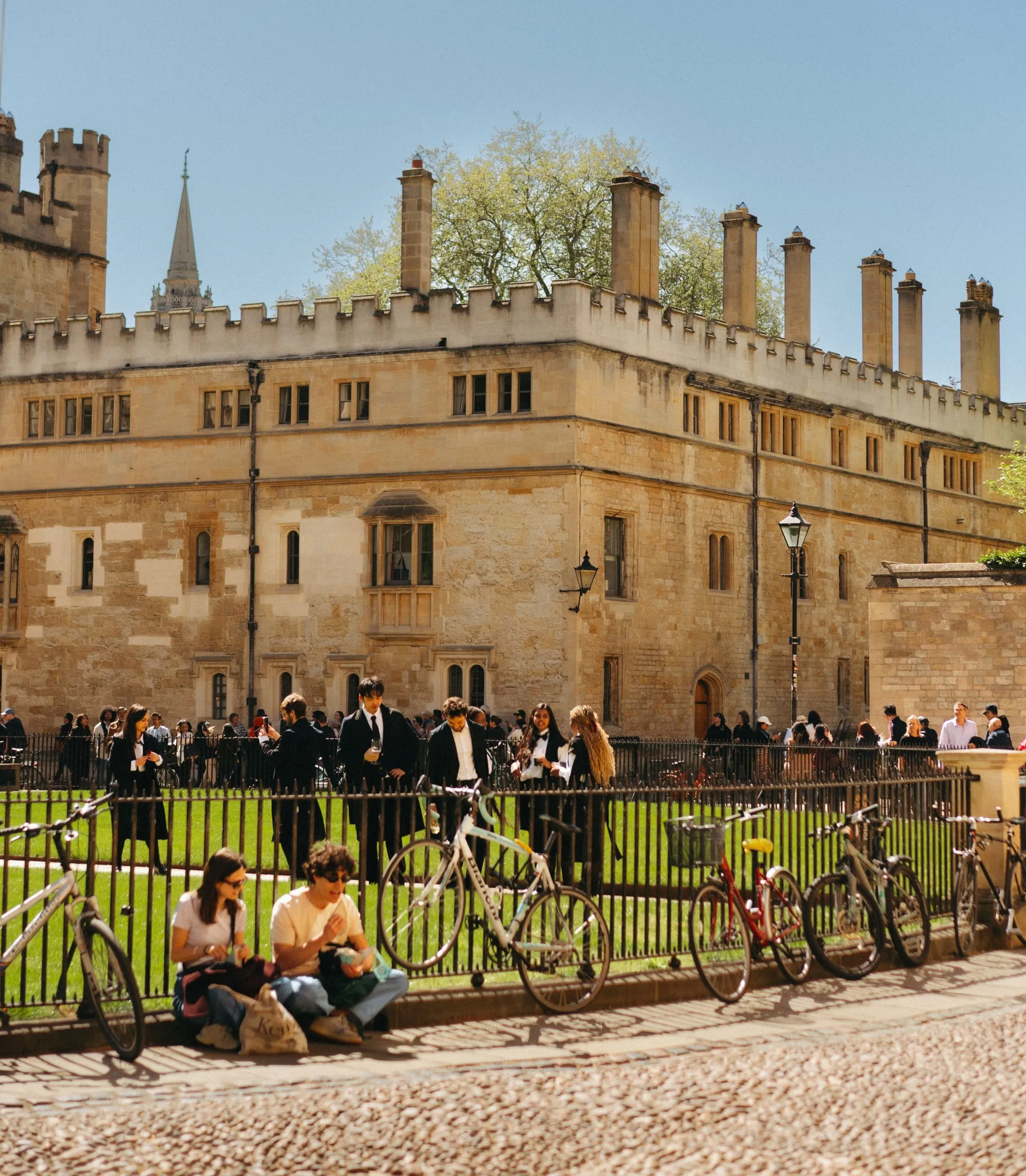 Students in Oxford sub fusc — dark suits, gowns and white bow ties — gathered outside a college in exam season