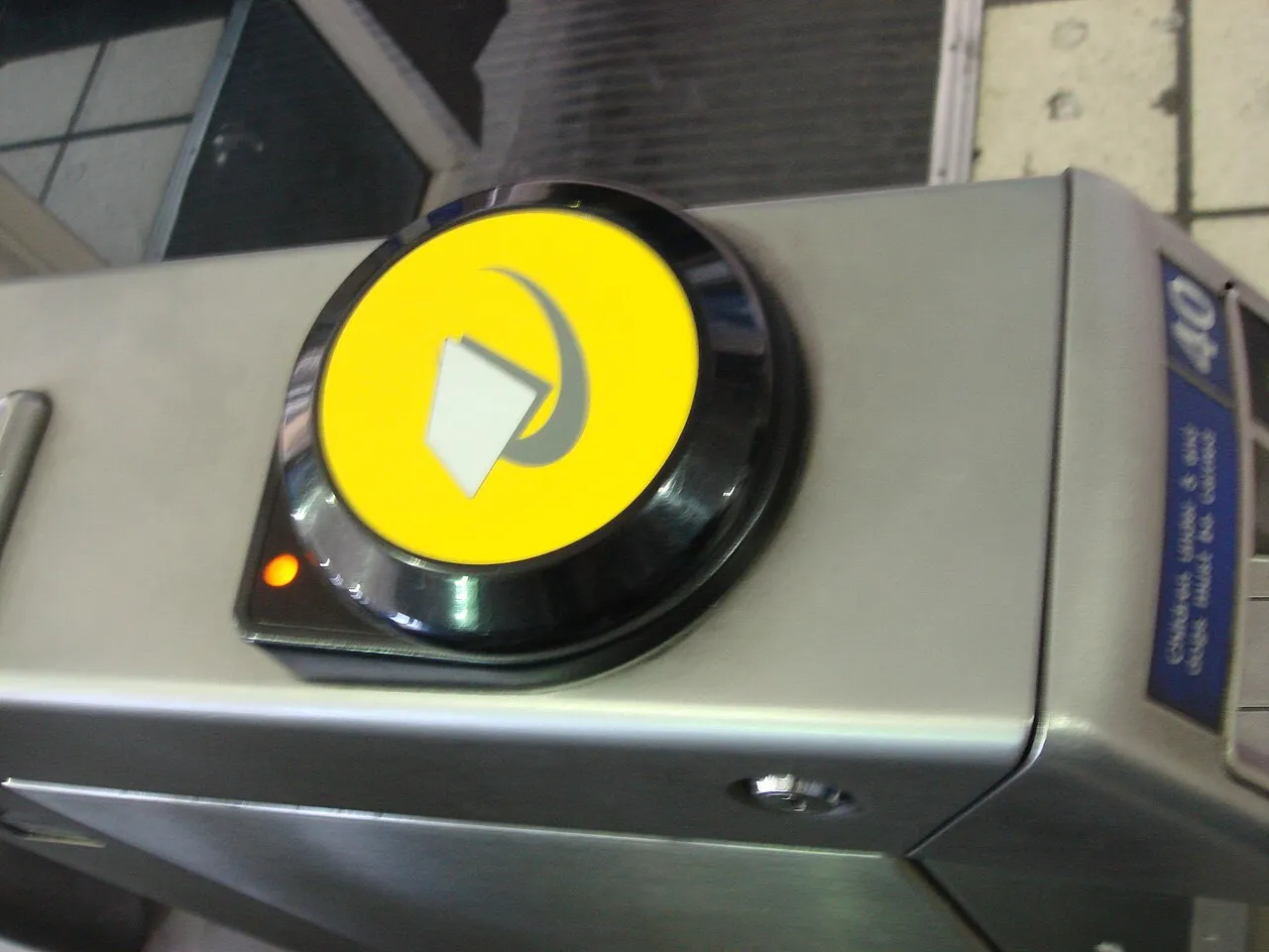 A yellow Oyster and contactless payment reader on a London Underground ticket gate
