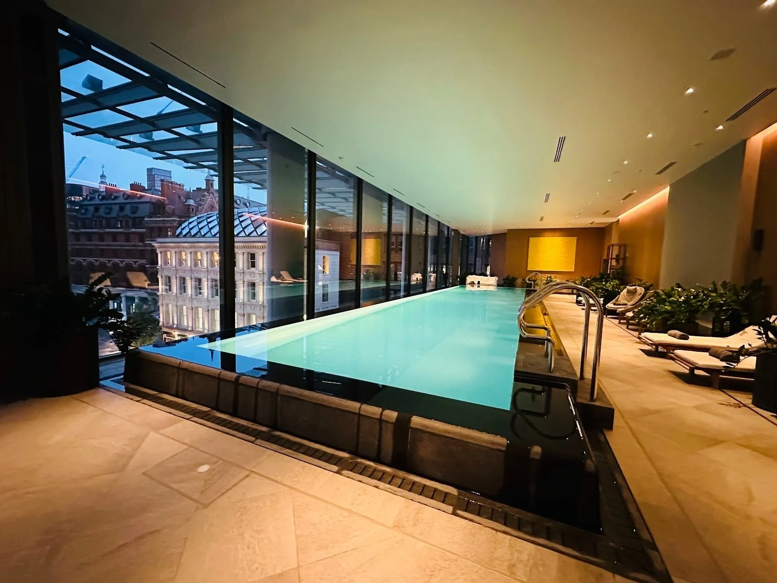 The pool at Pan Pacific London, with floor-to-ceiling windows over the City's rooftops