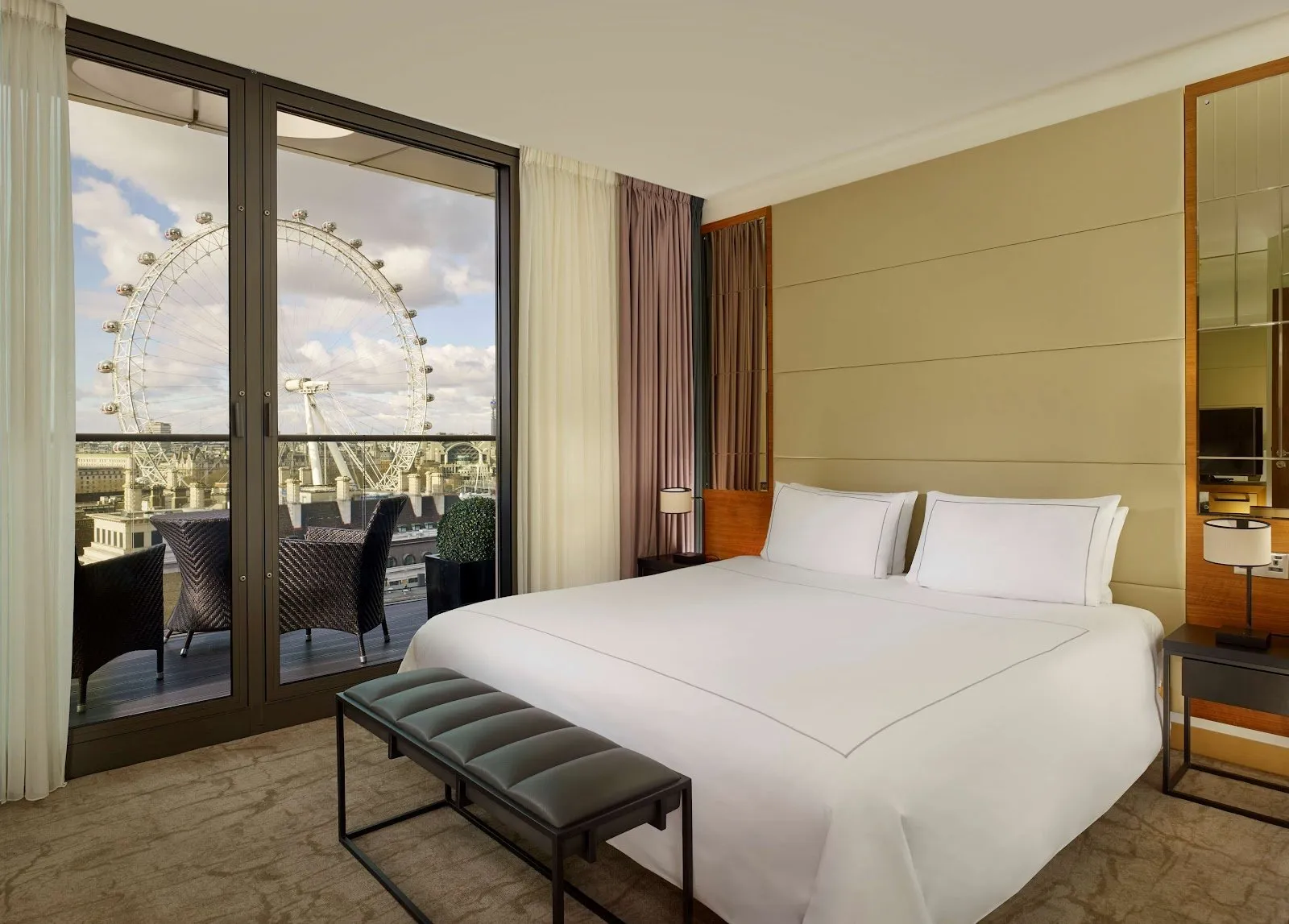 A hotel bedroom at Park Plaza County Hall with the illuminated wheel of the London Eye visible right outside the window