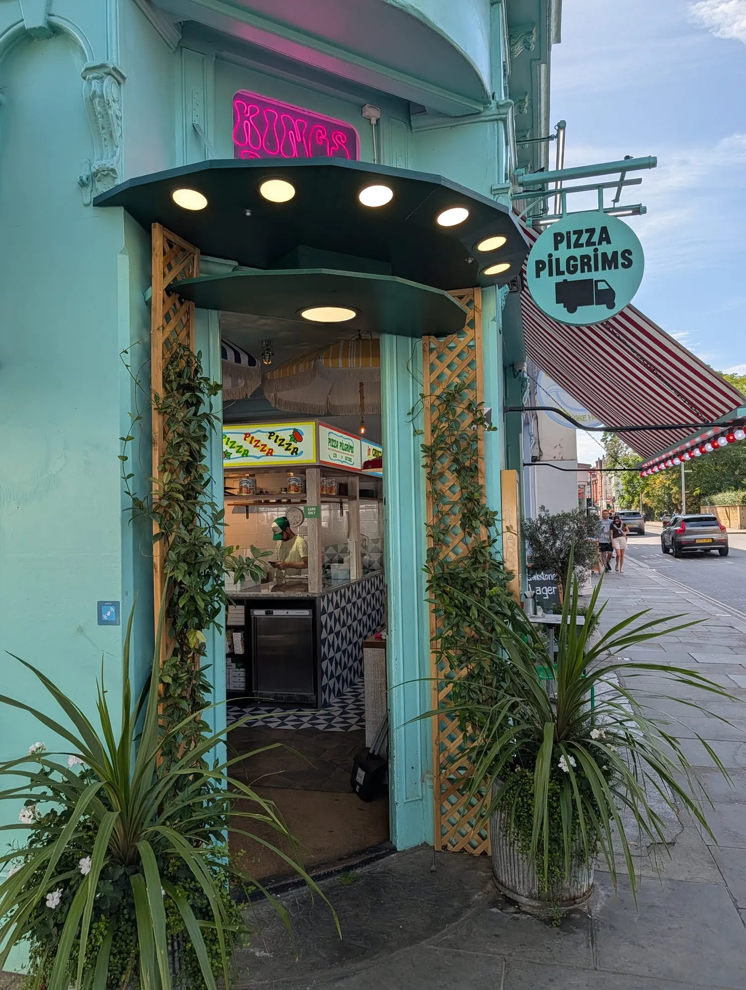 The Pizza Pilgrims shopfront on the King's Road, turquoise tiled frontage with an open window counter
