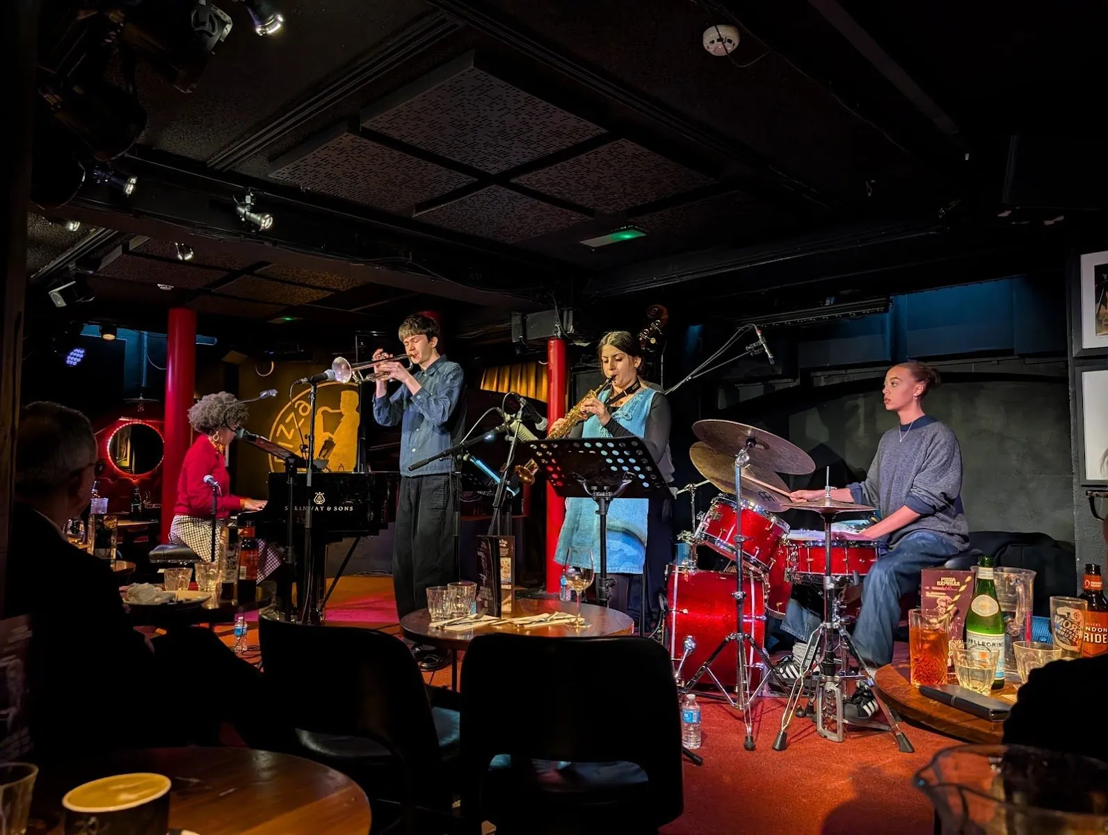 A five-piece band on piano, trumpet, saxophone and drums plays in the basement room, a few feet from diners' tables