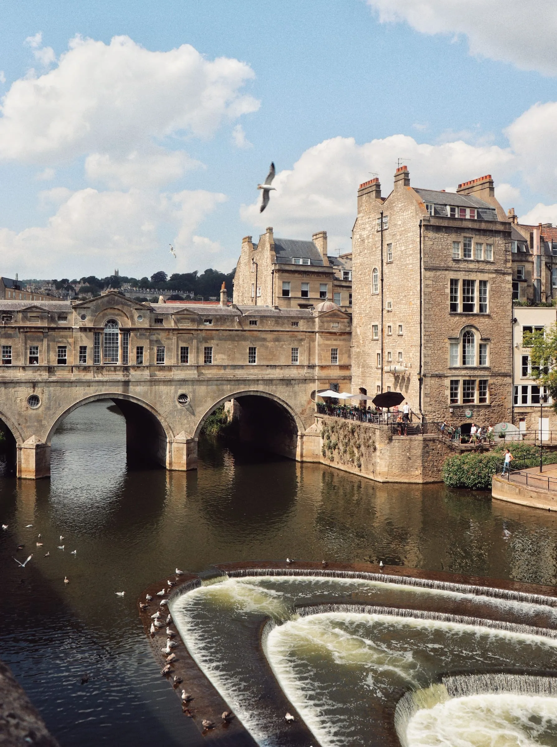Pulteney Bridge and the curved weir on the River Avon, shops built along the length of the bridge