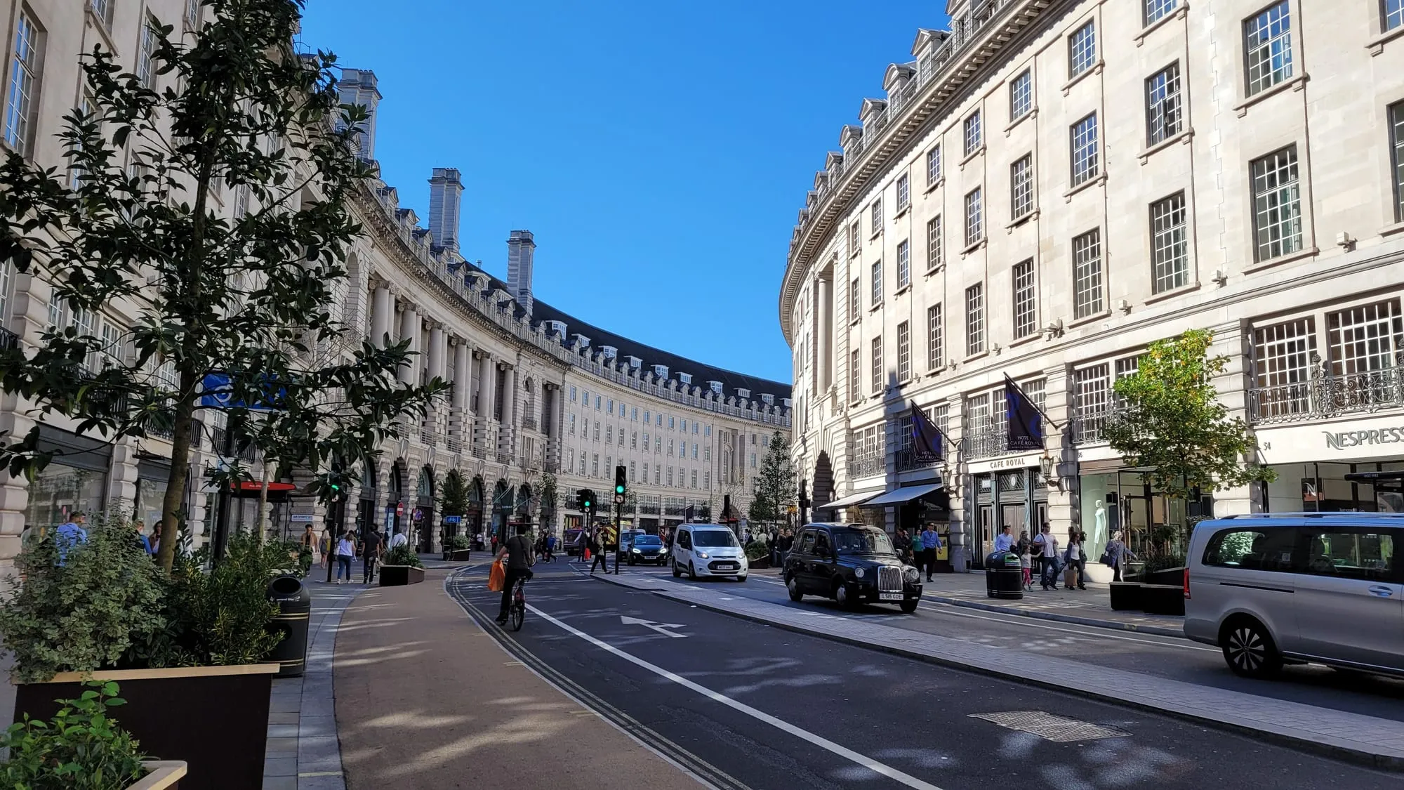 The curving Regent Street Quadrant with a black cab passing the Hotel Cafe Royal