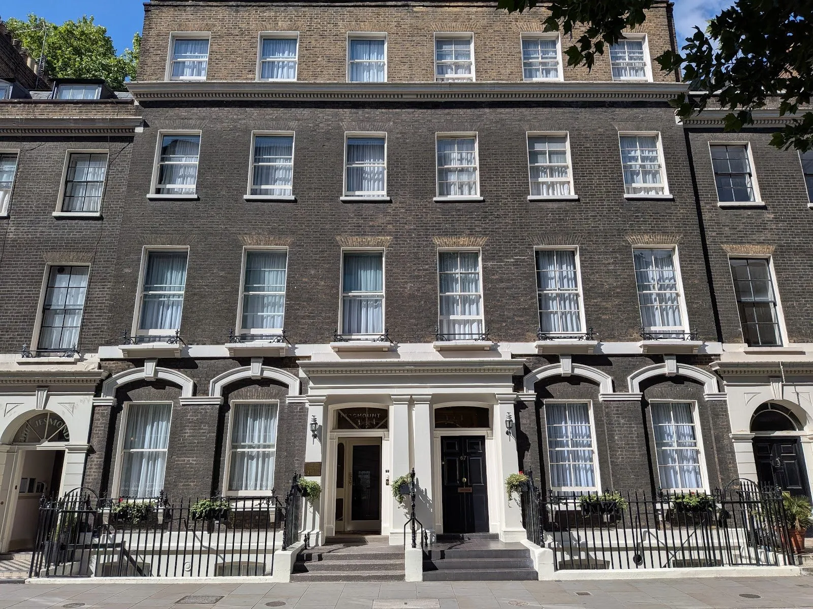 The Georgian brick facade of Ridgemount Hotel at 65-67 Gower Street with sash windows and wrought-iron railings