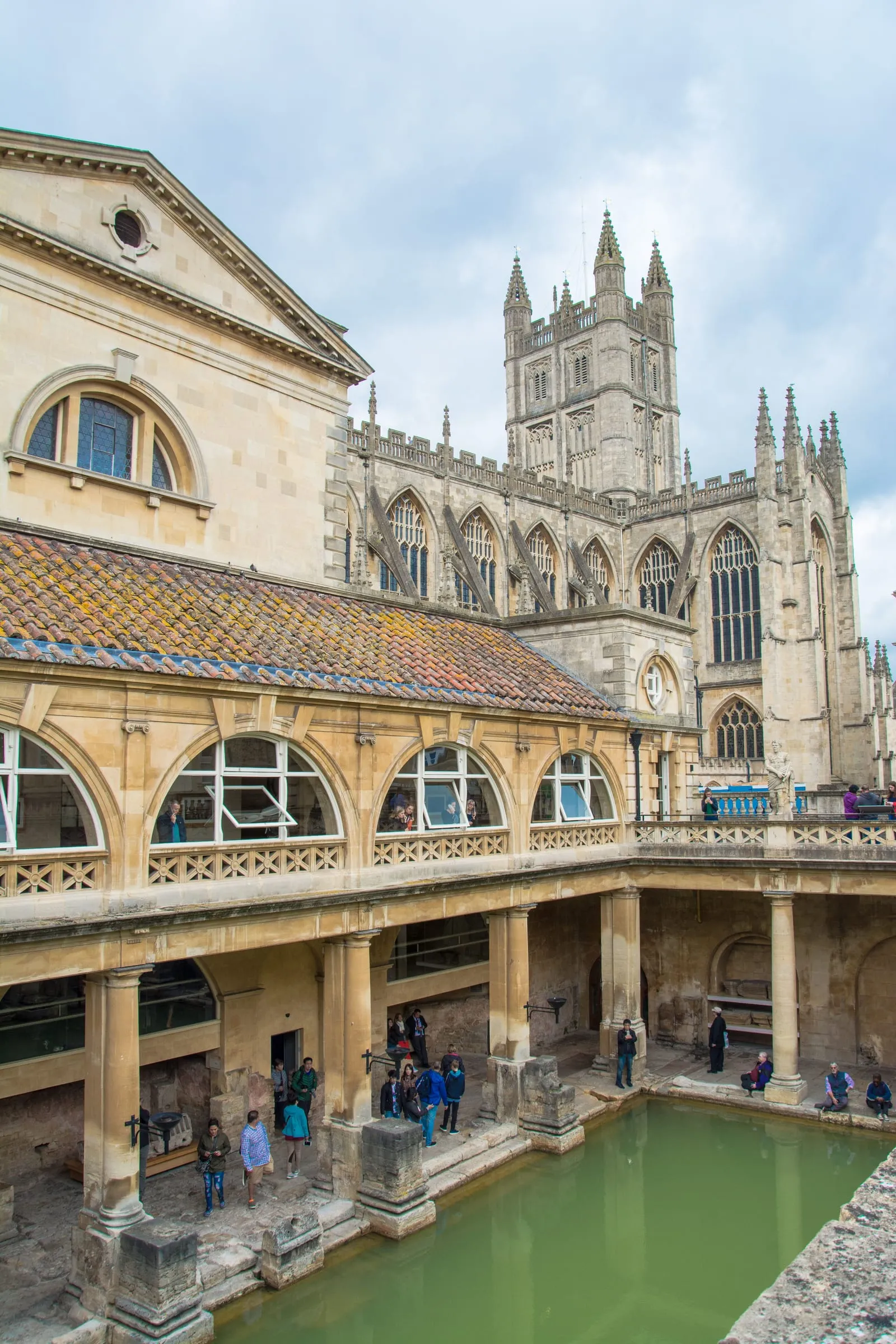 The terrace above the Great Bath at the Roman Baths, its statues along the balustrade with Bath Abbey rising behind