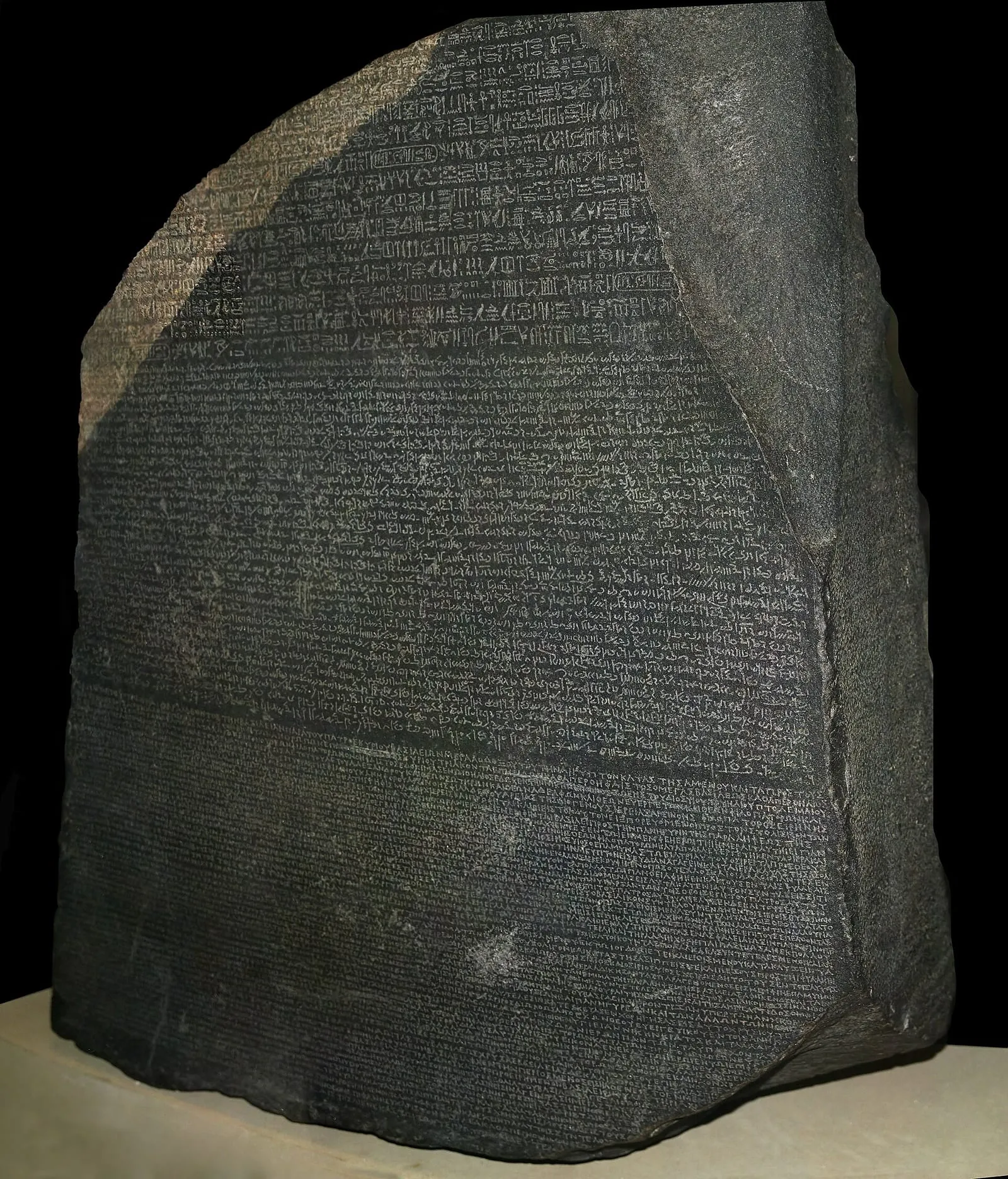 The Rosetta Stone, a dark granodiorite slab covered in lines of hieroglyphic, Demotic and Greek script