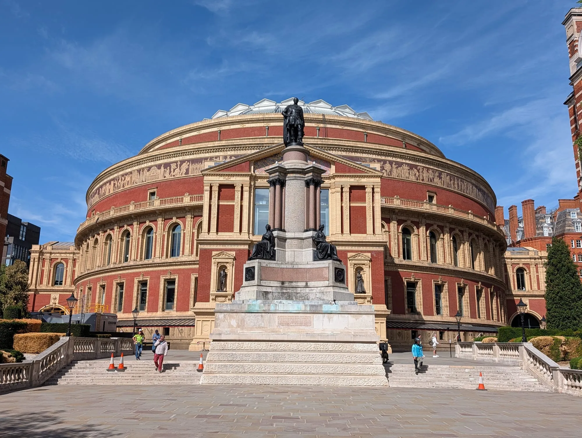 The Royal Albert Hall in low evening sun, with the Prince Consort memorial in front