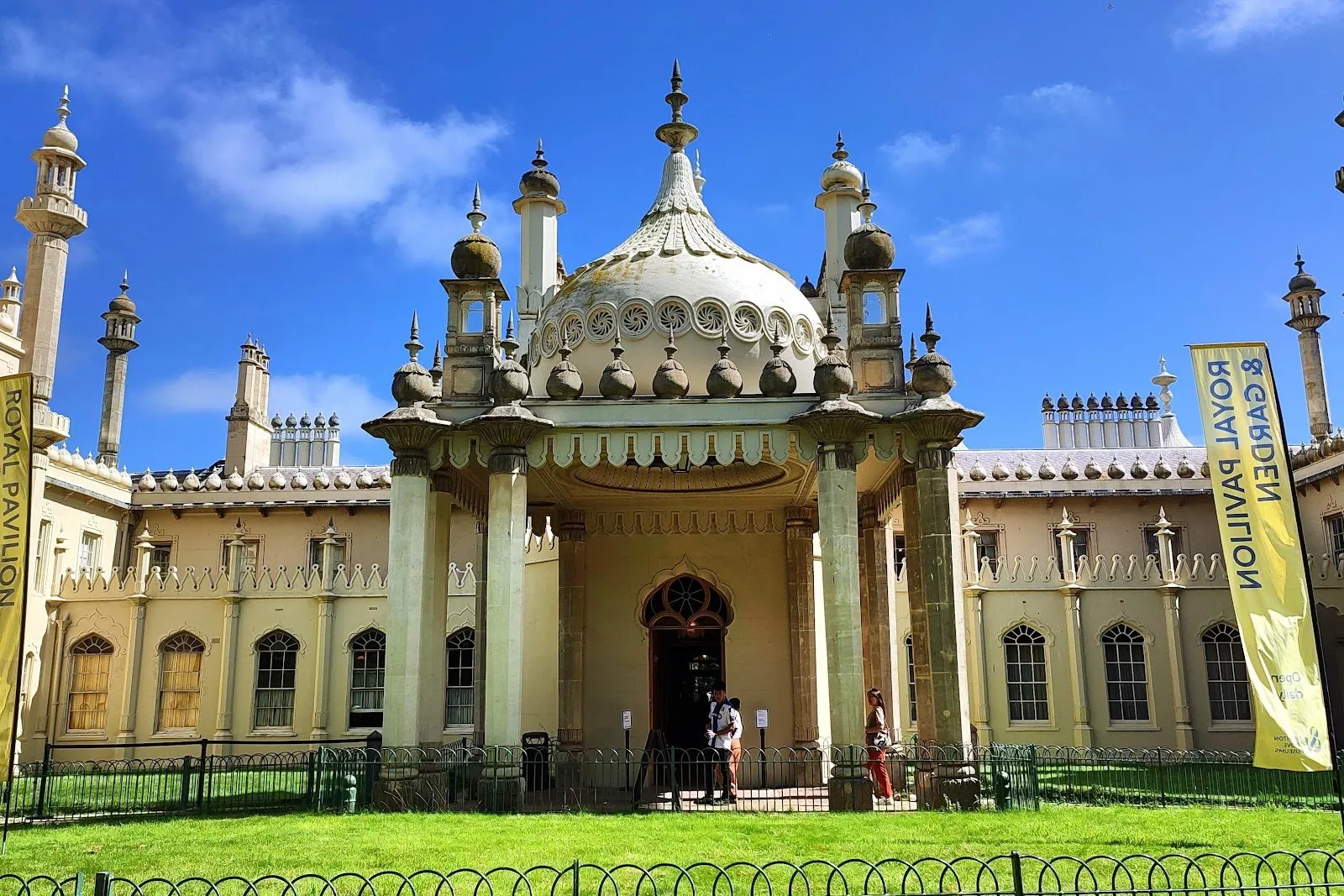 The Royal Pavilion's domed and pinnacled front entrance, seen from the lawn with visitors passing beneath its portico