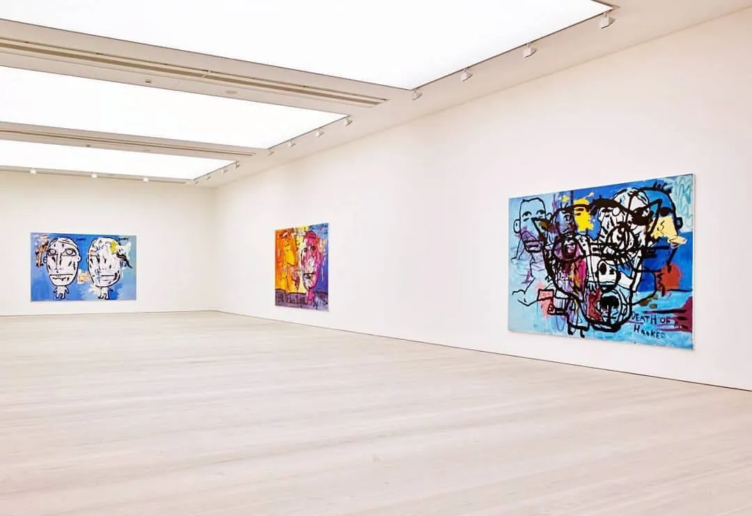 A white-walled gallery room at Saatchi Gallery with three colourful figurative paintings on the walls and a polished wood floor