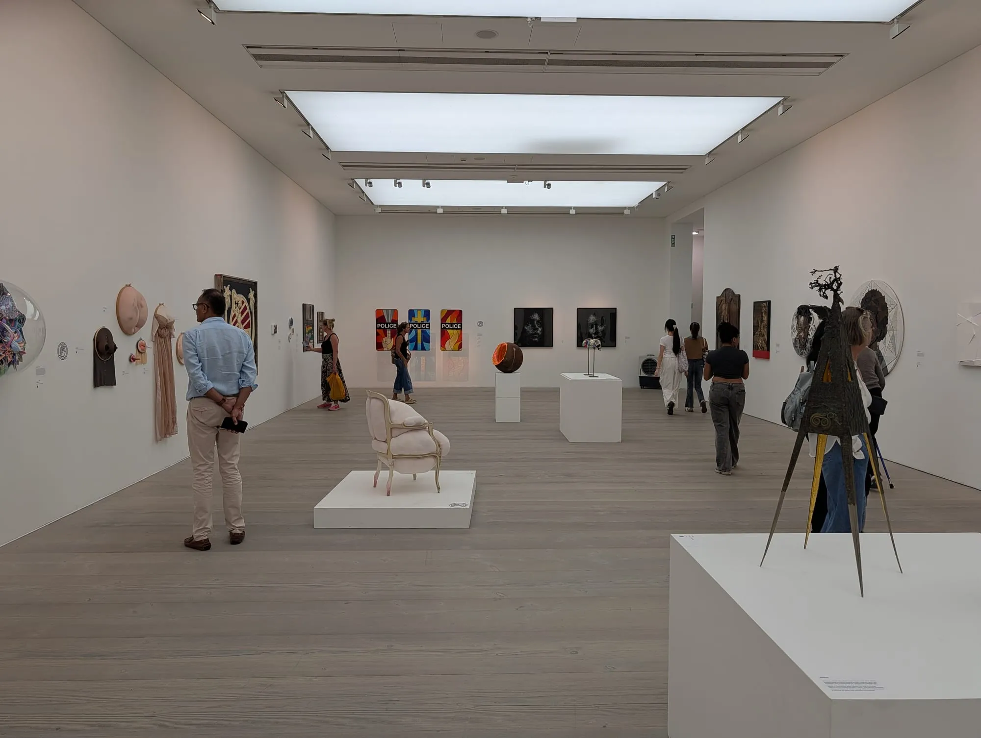 A white-walled gallery room at the Saatchi Gallery hung with framed prints