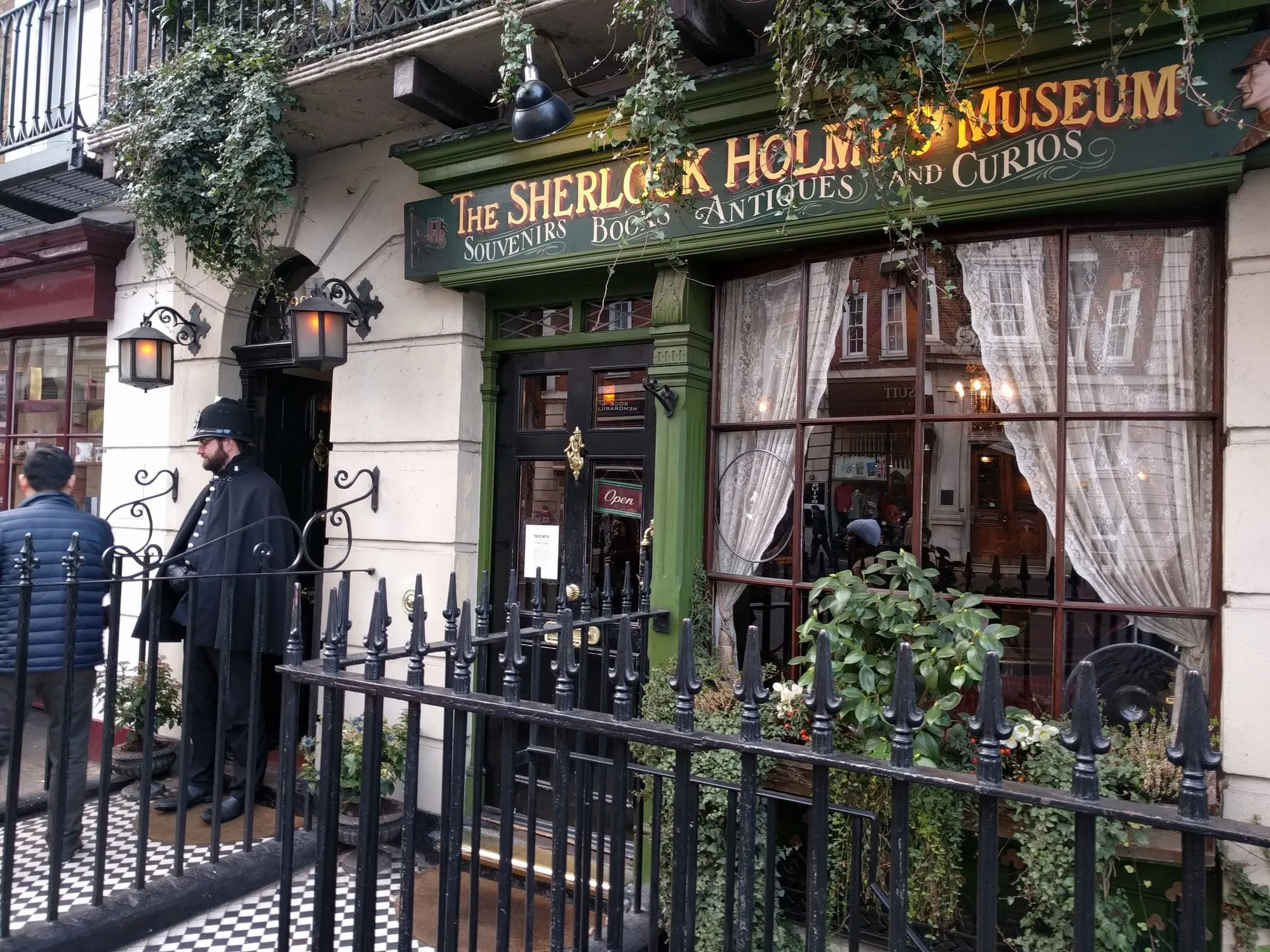 The Sherlock Holmes Museum shopfront on Baker Street, with a costumed Victorian policeman standing outside