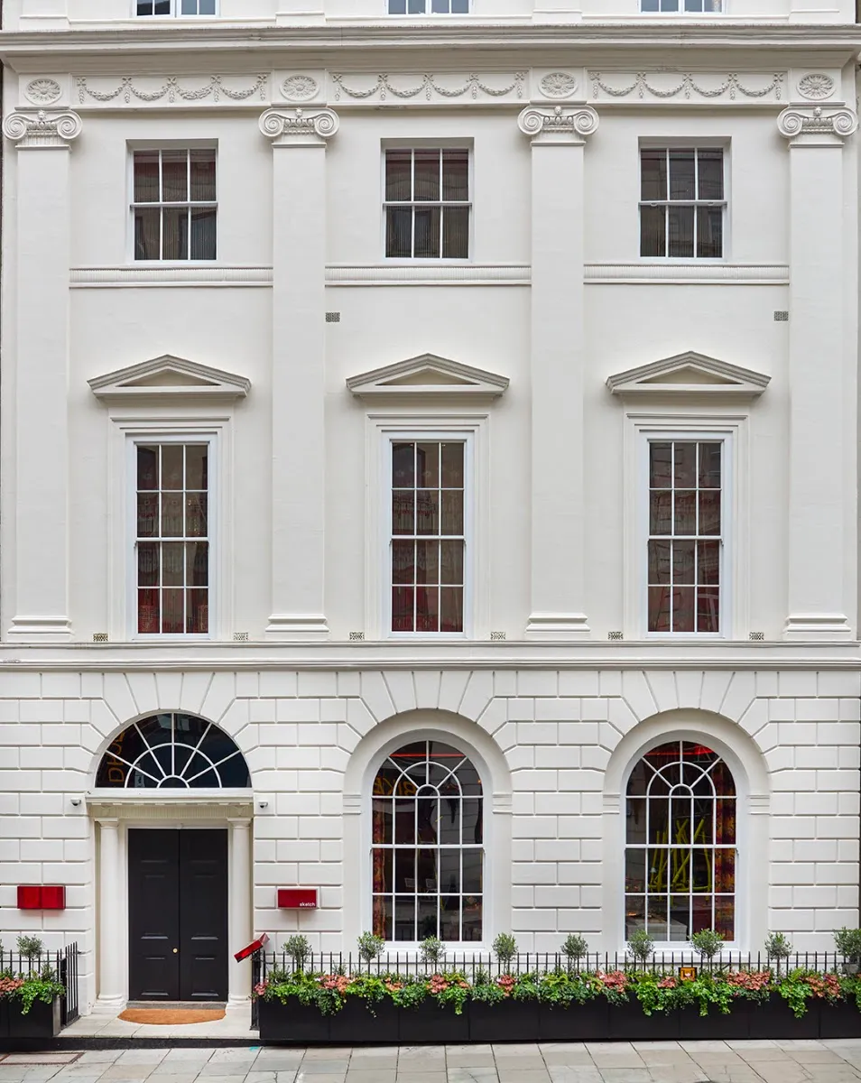 The Georgian stone frontage of sketch on Conduit Street, with a small red sketch sign beside the door