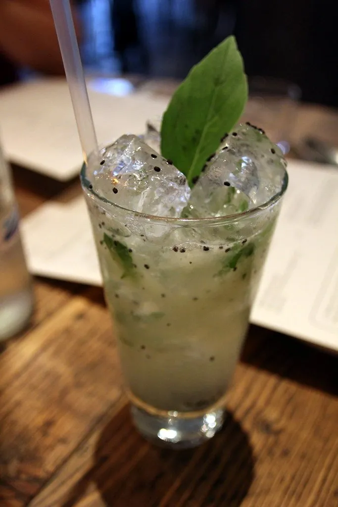A cocktail with mint in a tall glass