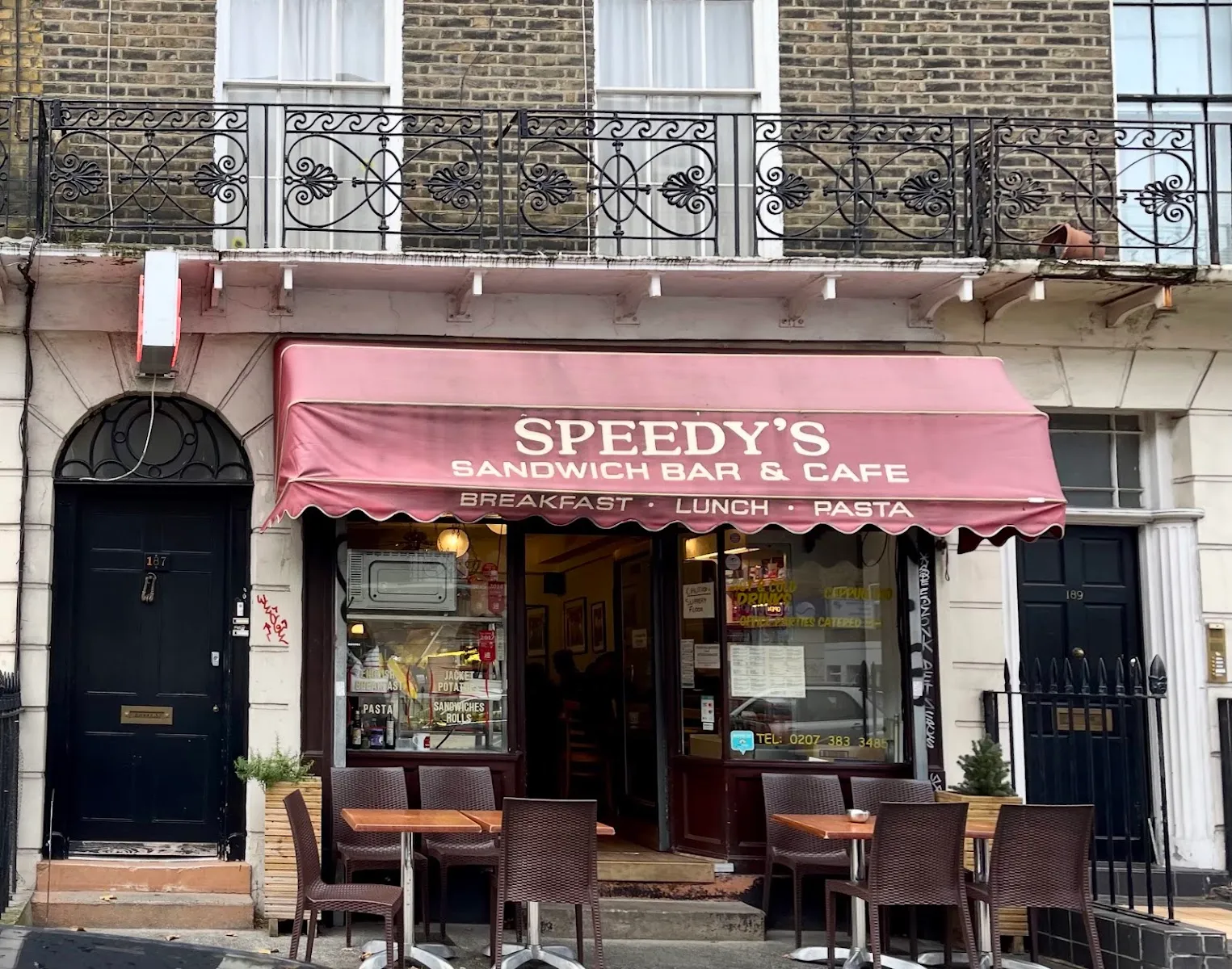 Speedy's Sandwich Bar and Café on North Gower Street, between two black Georgian doors numbered 187 and 189