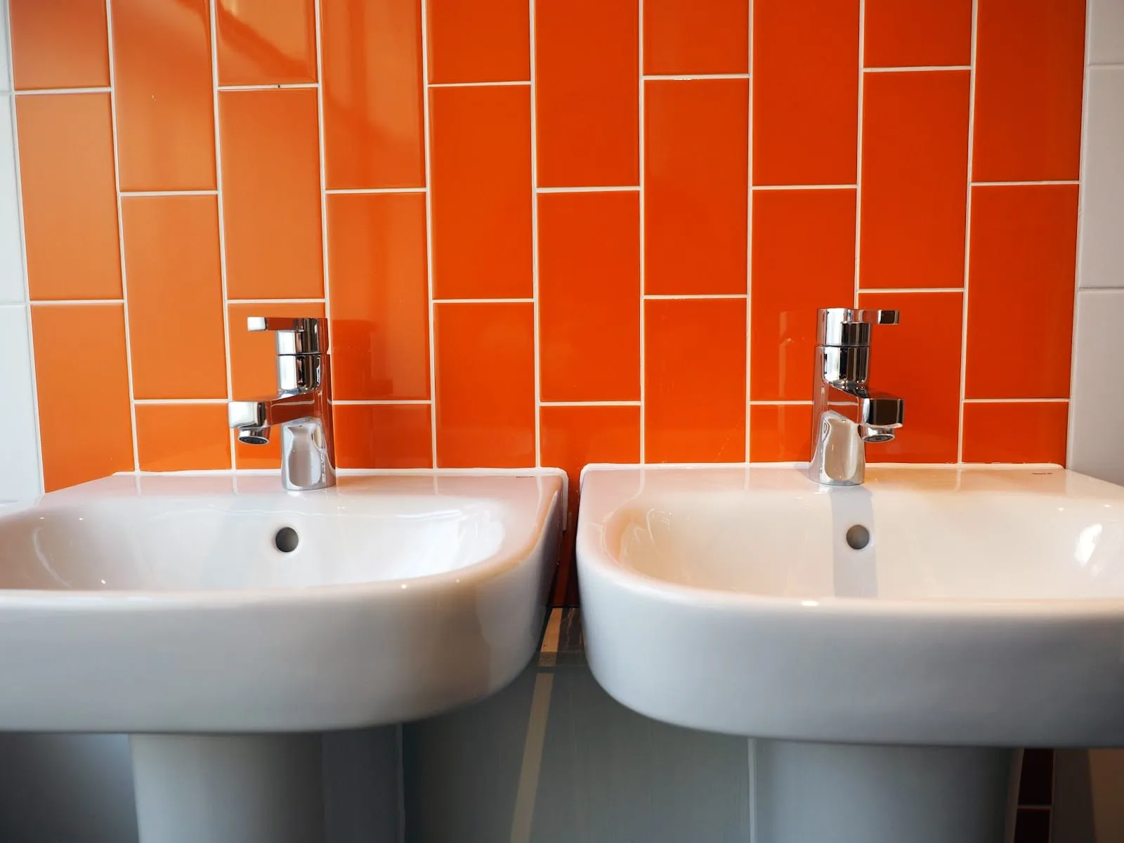 One of the shared bathrooms at St Christopher's Liverpool Street, tiled in orange