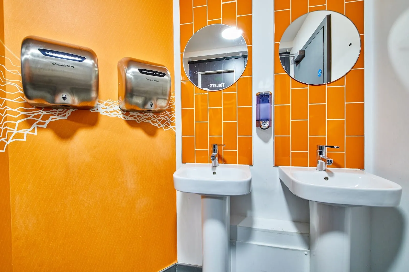 The shared bathroom facilities at St Christopher's Village, with a row of sinks and hand dryers