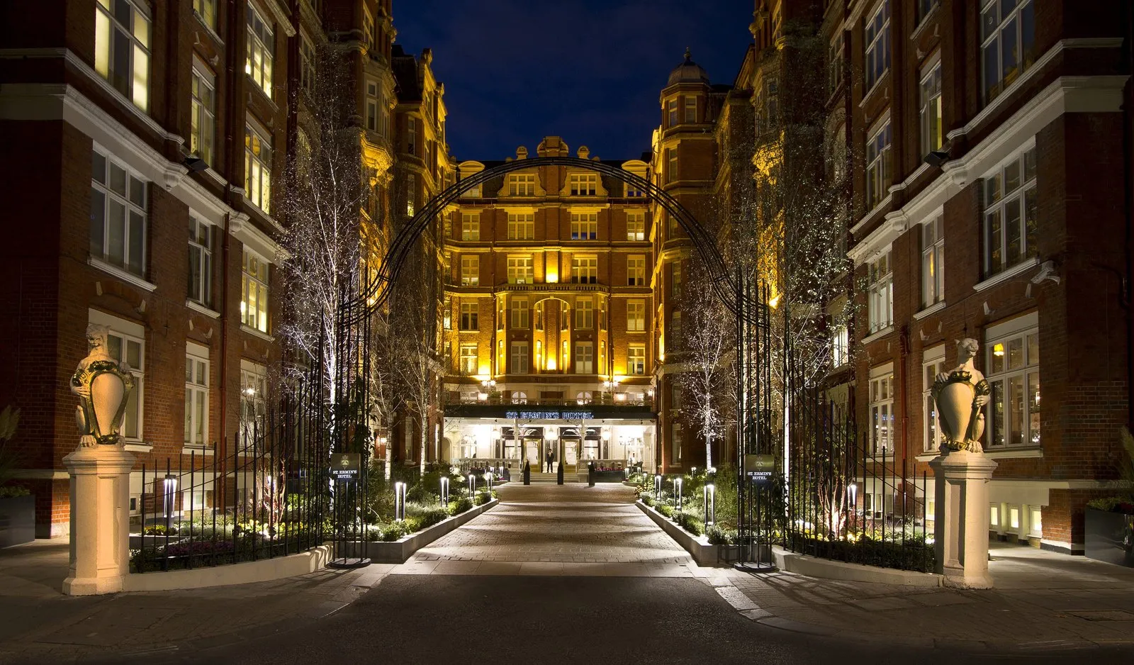 The leafy paved courtyard driveway leading to the red-brick facade of St. Ermin's Hotel in Westminster