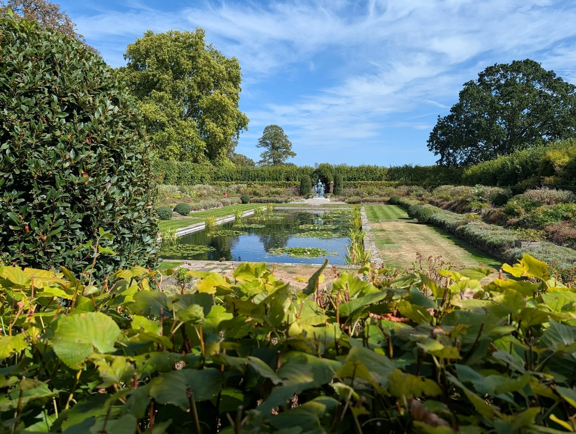 The Sunken Garden at Kensington Palace, a long formal pond edged with clipped hedges and dense flower borders