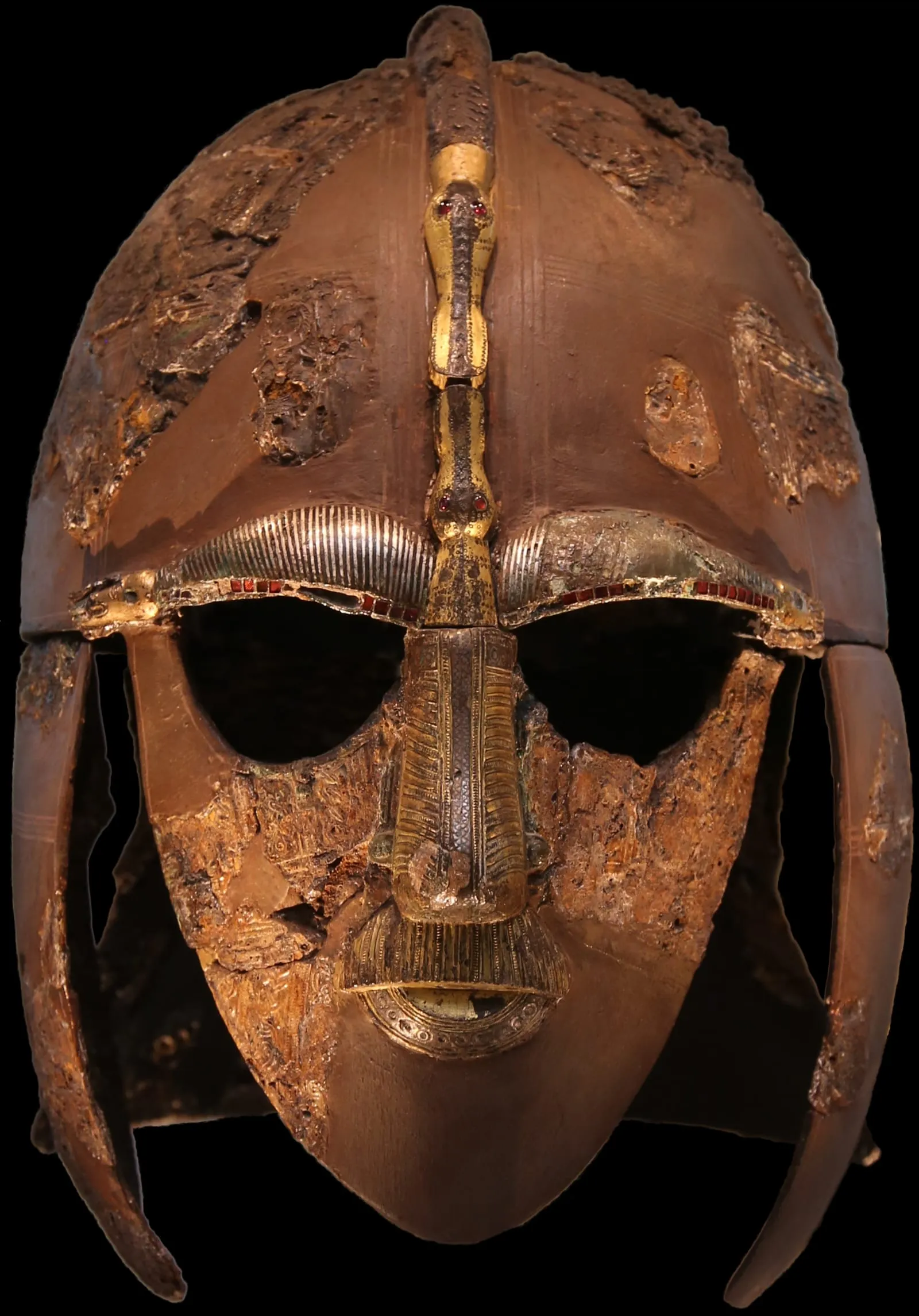 The Sutton Hoo helmet, an Anglo-Saxon iron helmet with a gilded bronze face mask, eyebrows and nose, shown against a black background
