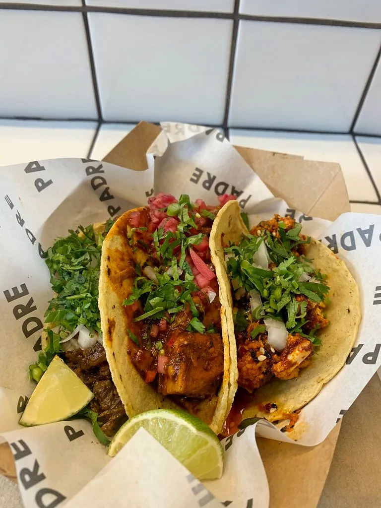 Two tacos on corn tortillas with salsa and coriander