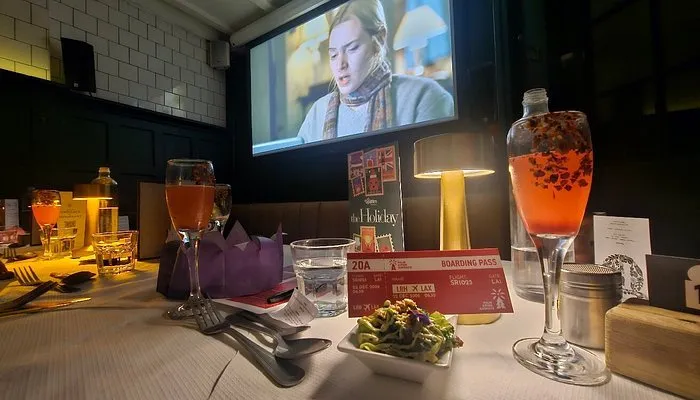 A table laid with themed cocktails and a starter in front of the screen during a Taste Film dinner