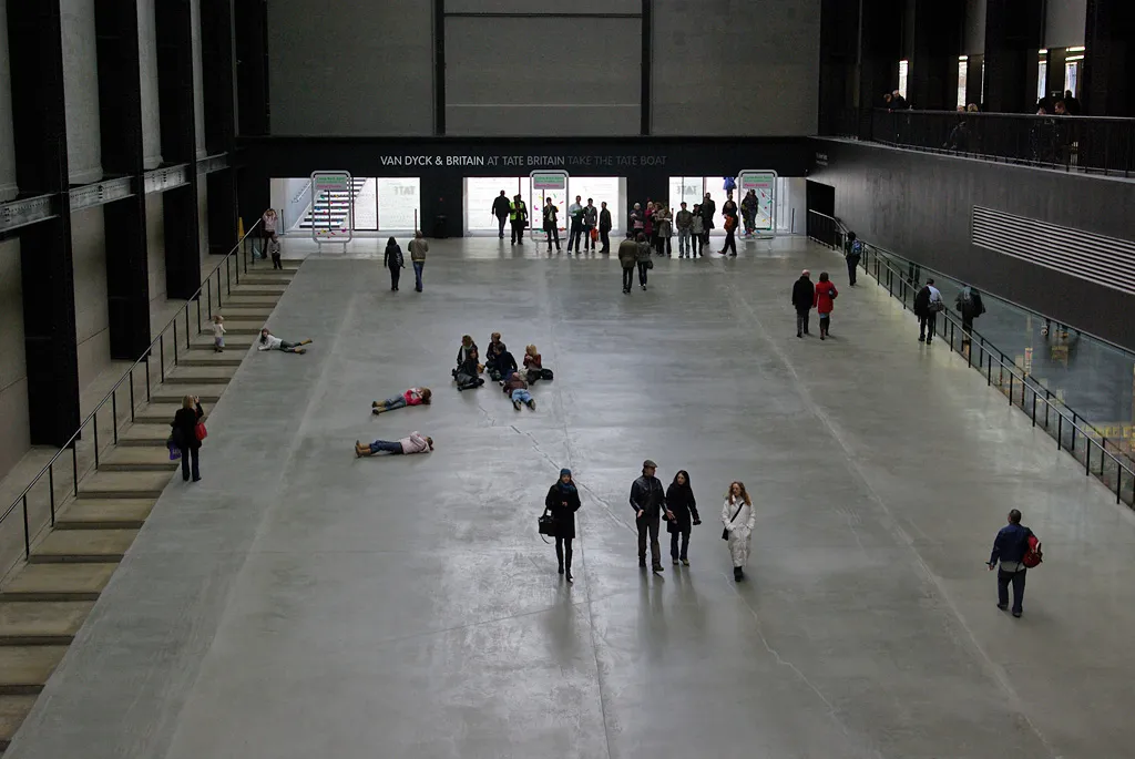 The wide concrete ramp running down into the Turbine Hall at Tate Modern, with people walking in from the west entrance