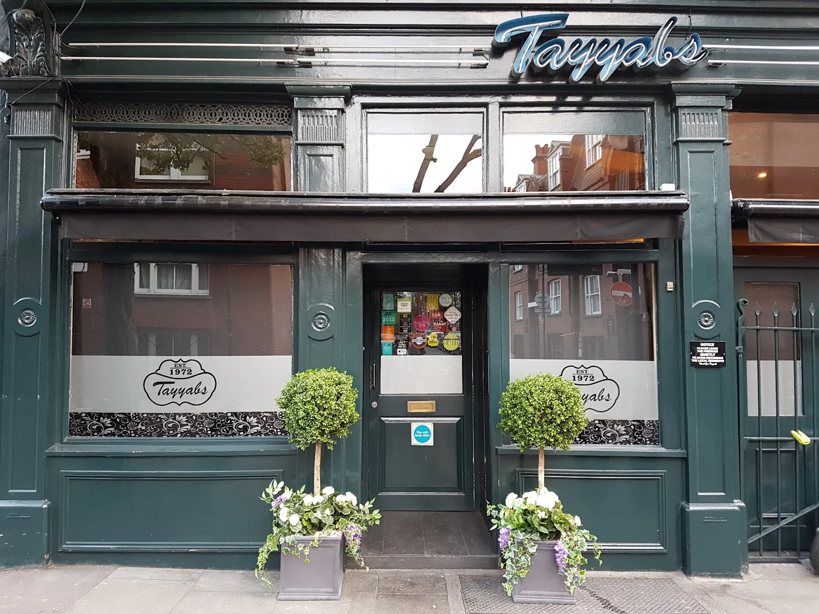 The dark green shopfront of Tayyabs on Fieldgate Street, with "EST. 1972" lettered on the windows