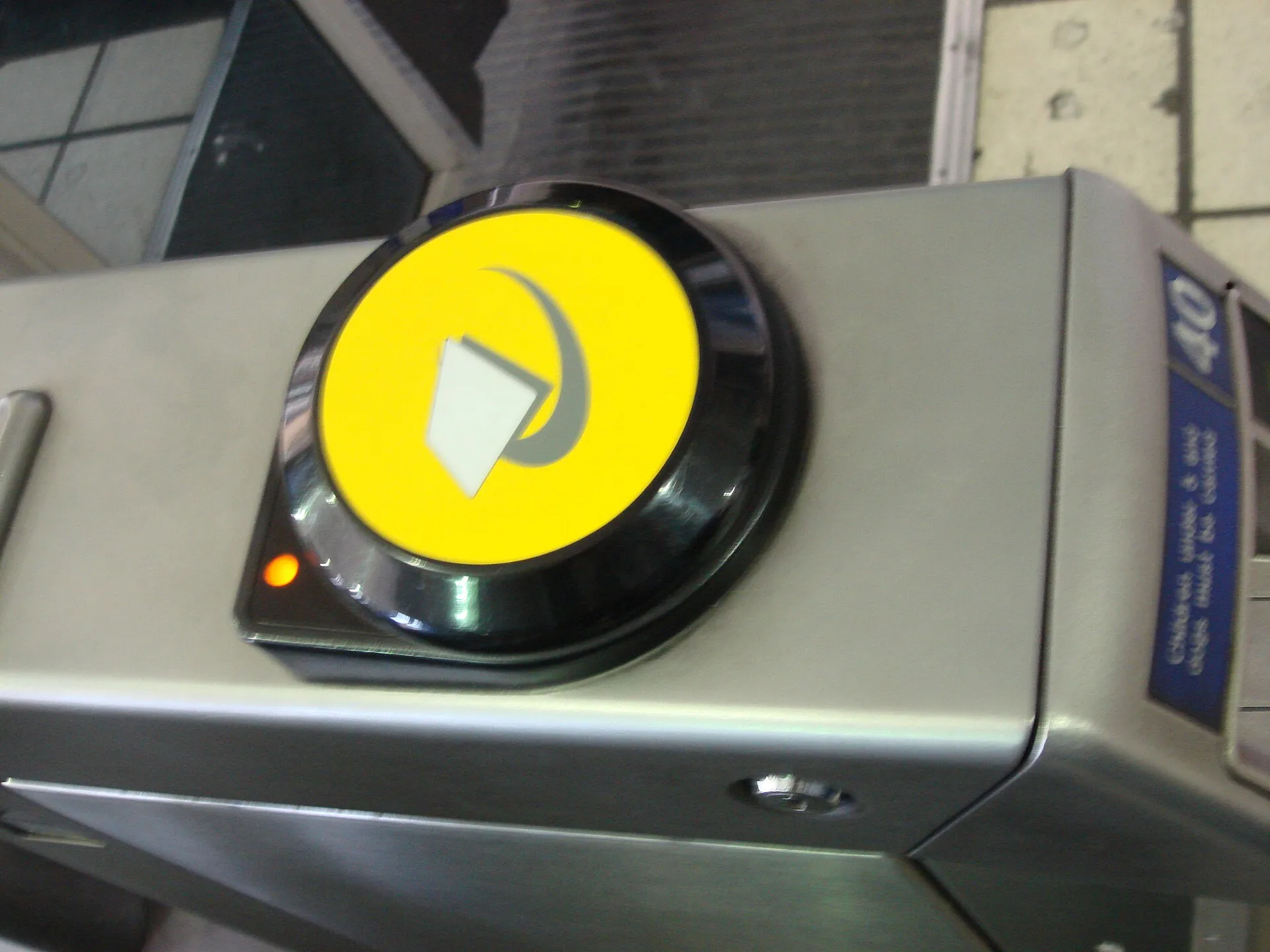 The circular yellow card reader on a London Underground ticket barrier
