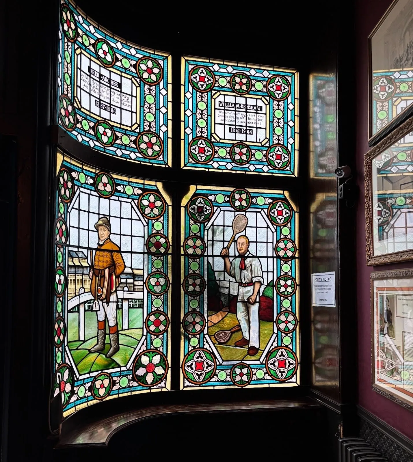 Stained glass at The Champion depicting the jockey Fred Archer and the tennis champion William Renshaw, with their names and dates lettered beneath