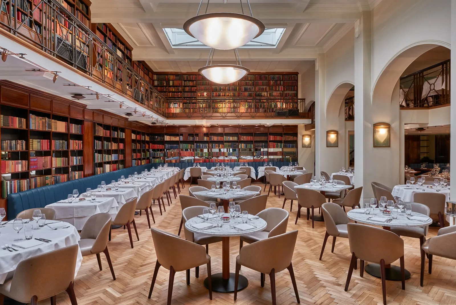 The double-height former Westminster Library dining room at the Cinnamon Club, with bookshelves lining both levels