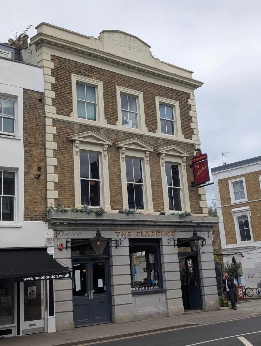 The exterior of The Clarence Tavern on Church Street, a Georgian corner building with a red pub sign