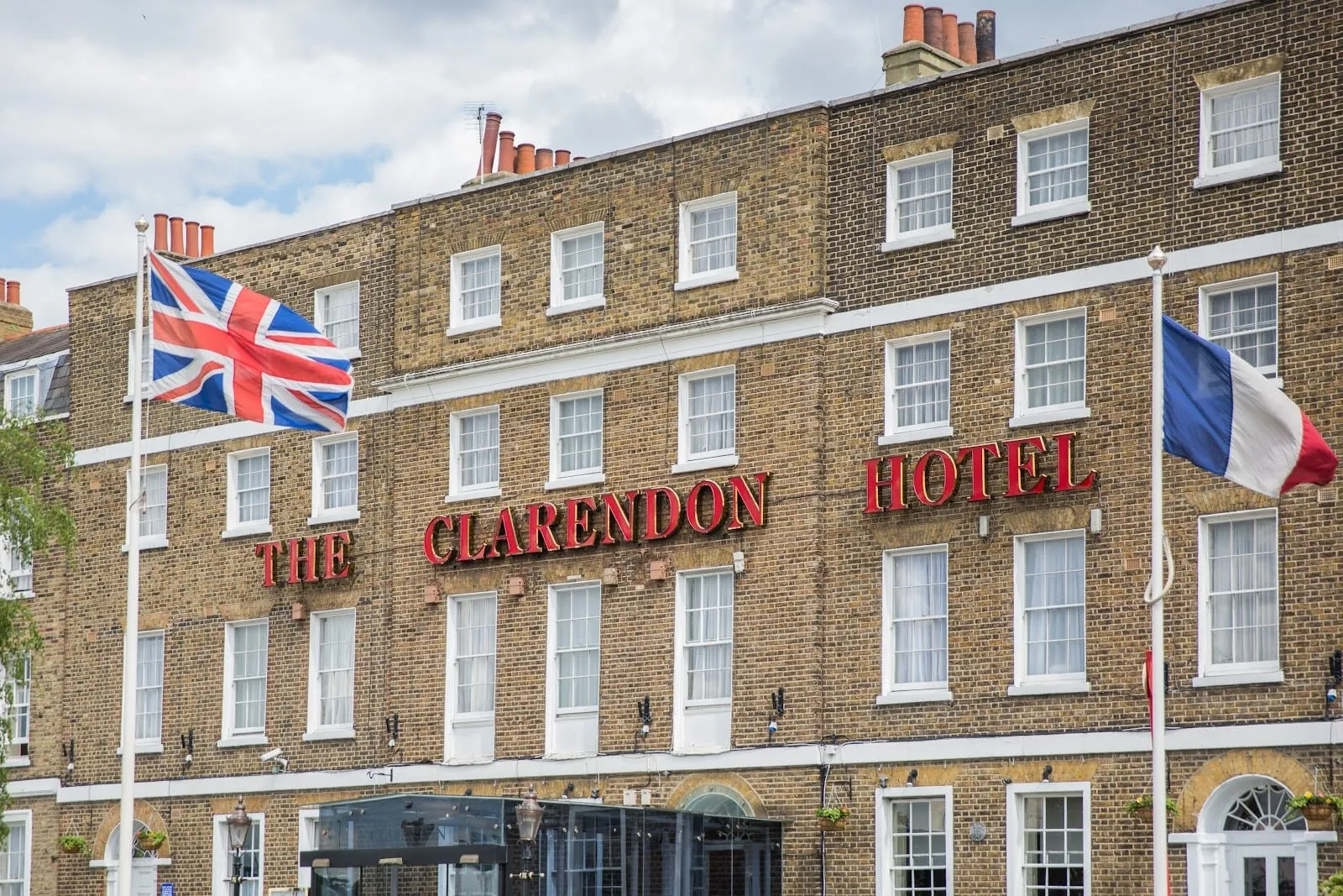The brick front of The Clarendon Hotel in Blackheath, with its red lettering and flags
