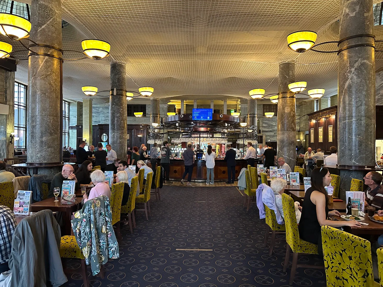 The marble-columned former banking hall of the Crosse Keys, now a Wetherspoons, with a circular bar in the centre
