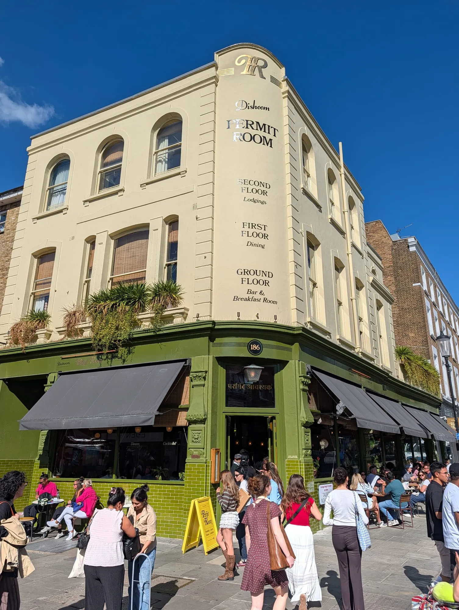 The Distillery on Portobello Road, a corner building with a deep green ground floor and cream upper storeys