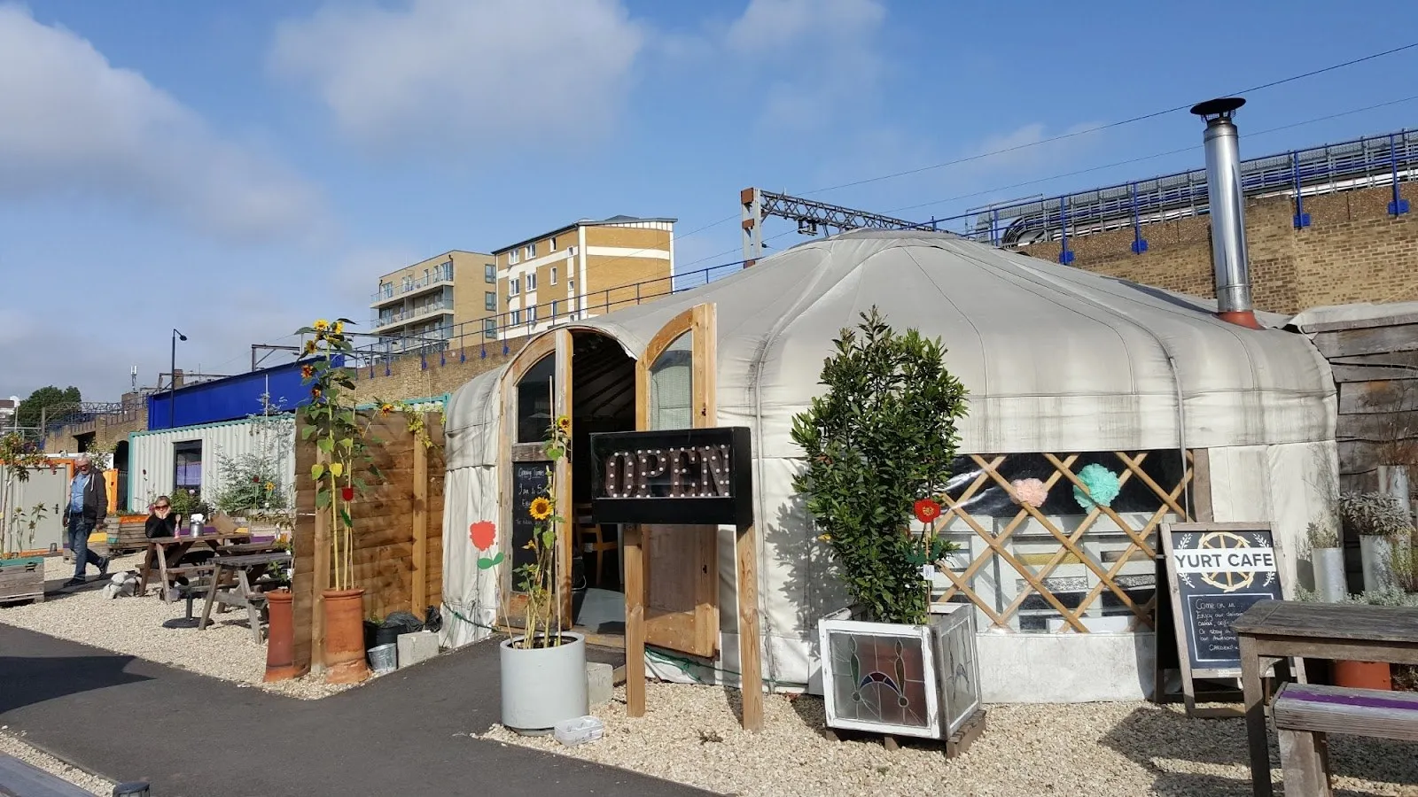 The Yurt Café, a canvas yurt with outdoor tables under a railway arch