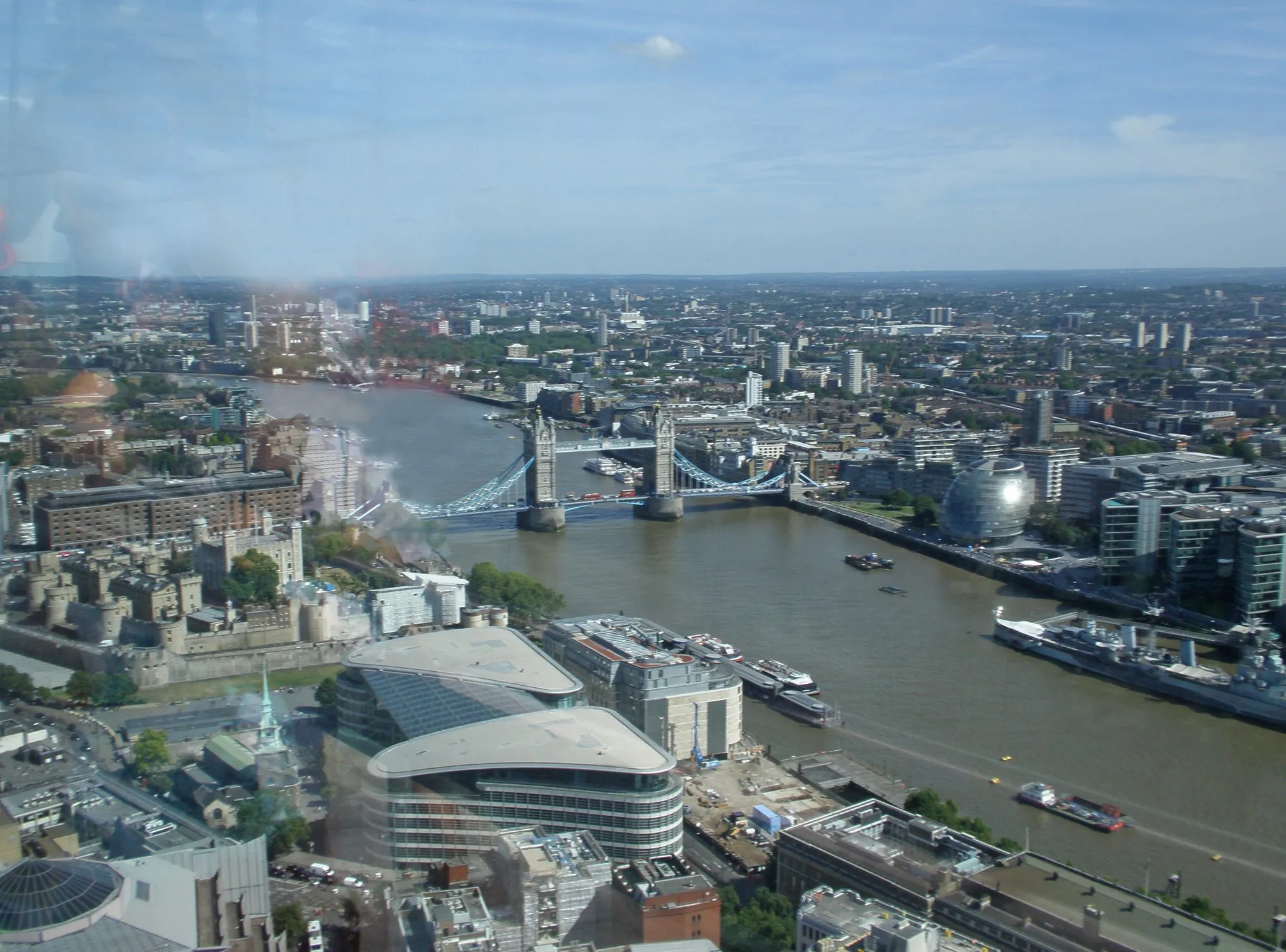 The Tower of London, Tower Bridge, HMS Belfast and City Hall's glass dome on the Thames, seen from high above