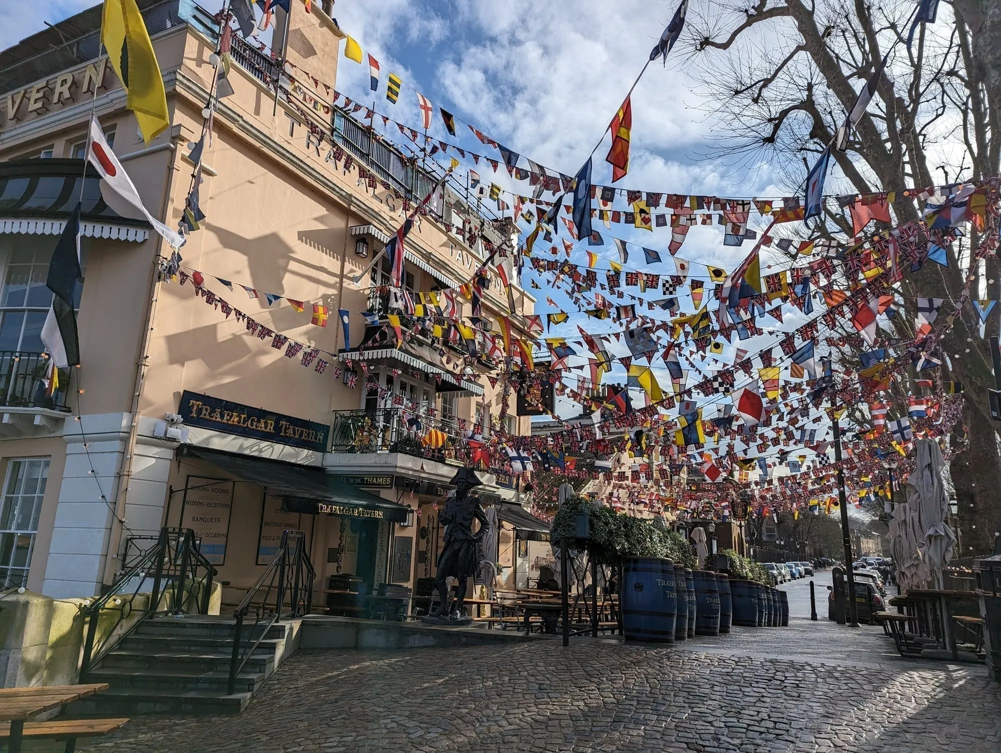 The Trafalgar Tavern's riverside terrace strung with rows of colourful nautical signal flags