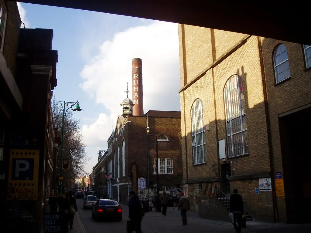 The Truman Brewery chimney and clock tower rising over Brick Lane