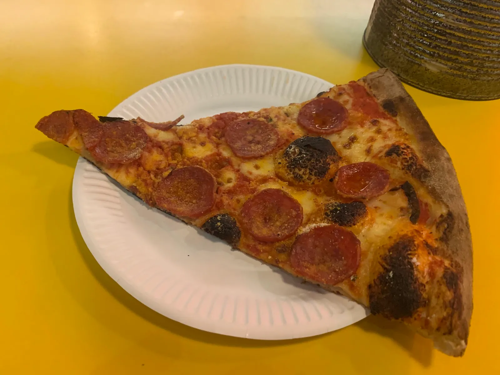 A giant pepperoni pizza slice on a paper plate at Voodoo Ray's, Dalston